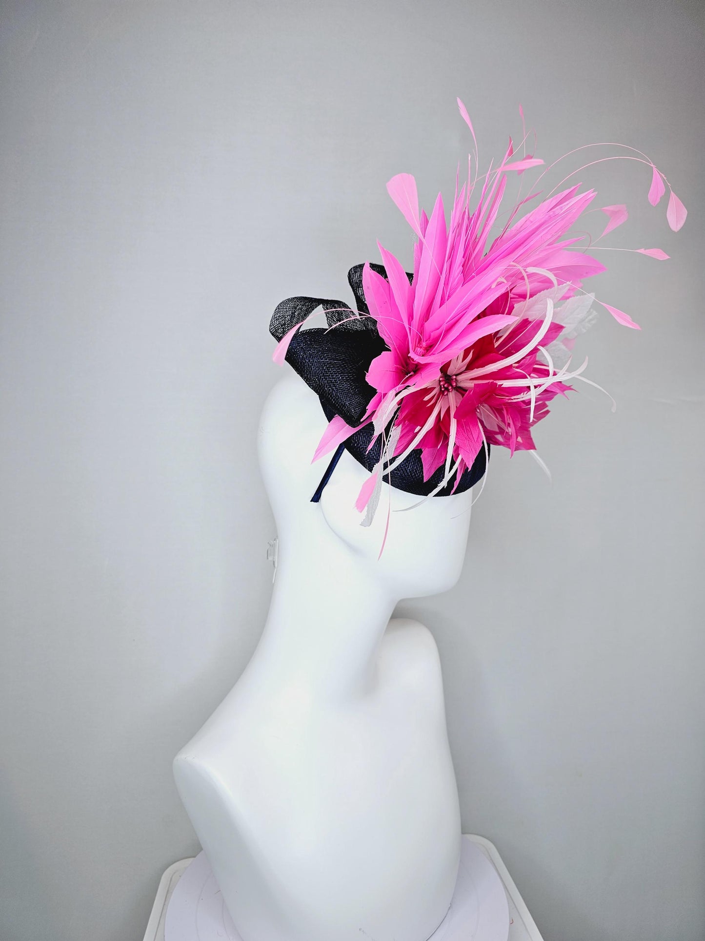 kentucky derby hat fascinator navy blue sinamay with hot pink feather flower, white velvet leaves and blush pink branching feathers