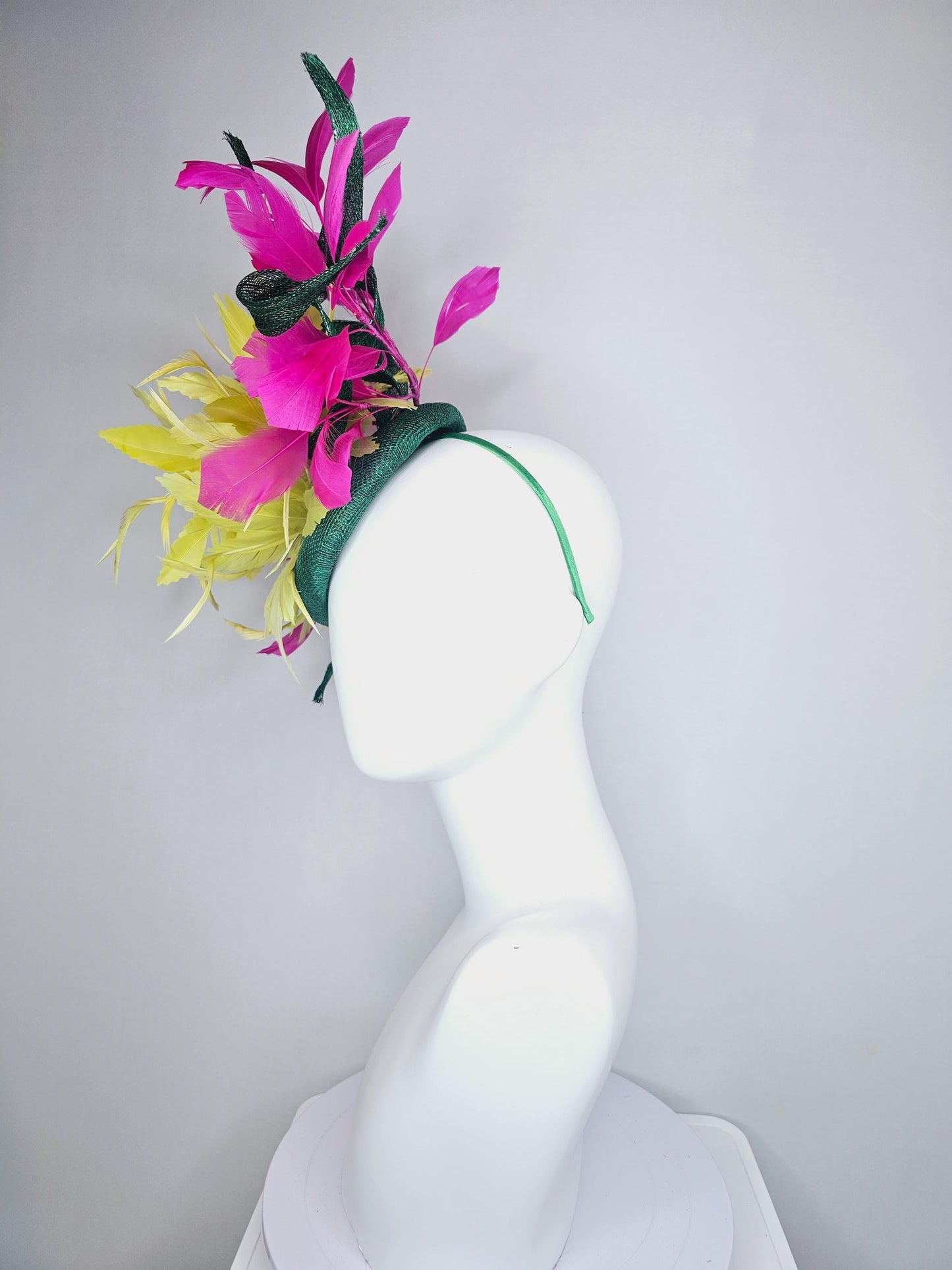 kentucky derby hat fascinator dark green sinamay with curls and fluffy yellow zigzag feather flower, bright pink fuchsia branching feathers