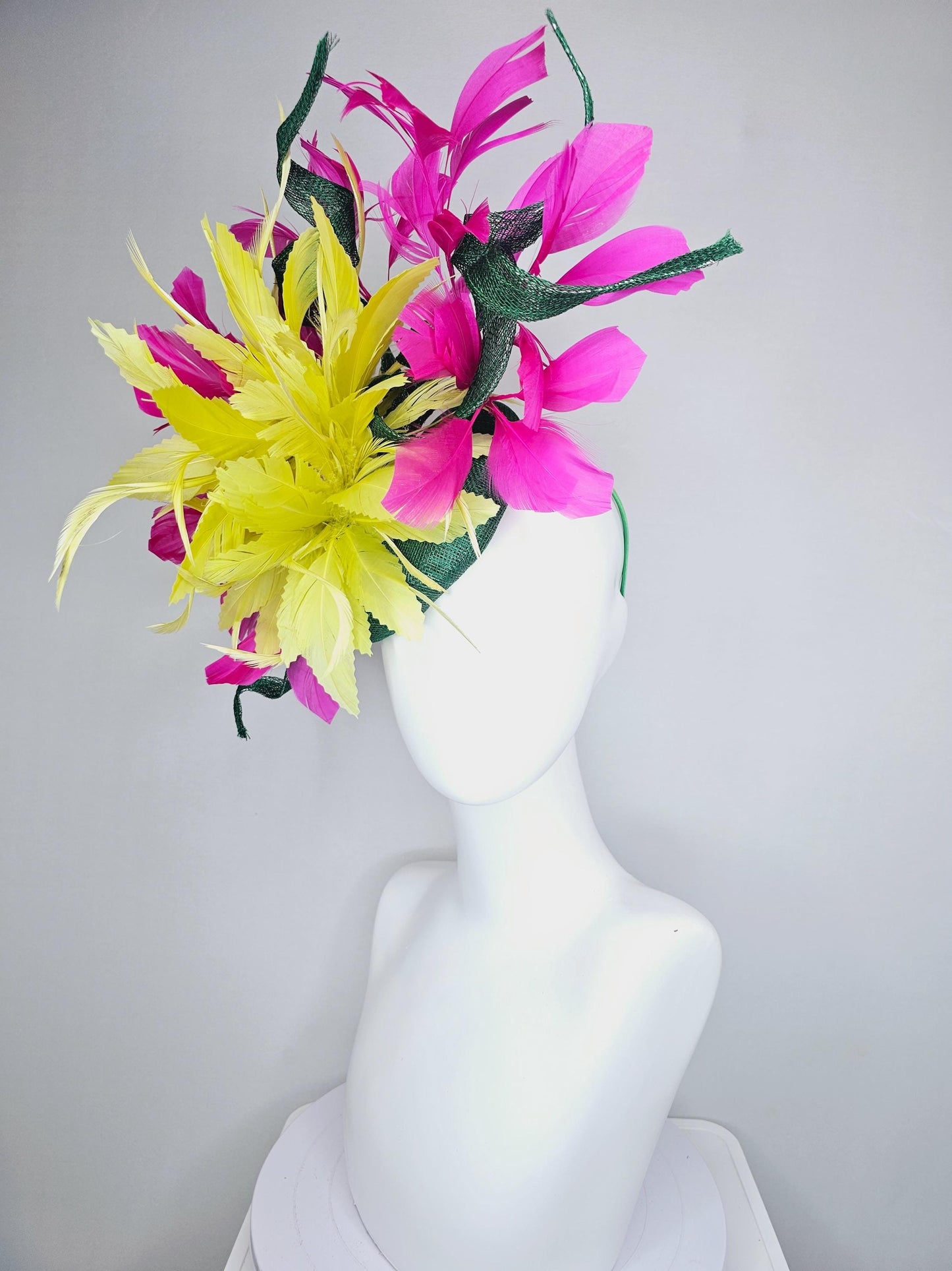 kentucky derby hat fascinator dark green sinamay with curls and fluffy yellow zigzag feather flower, bright pink fuchsia branching feathers