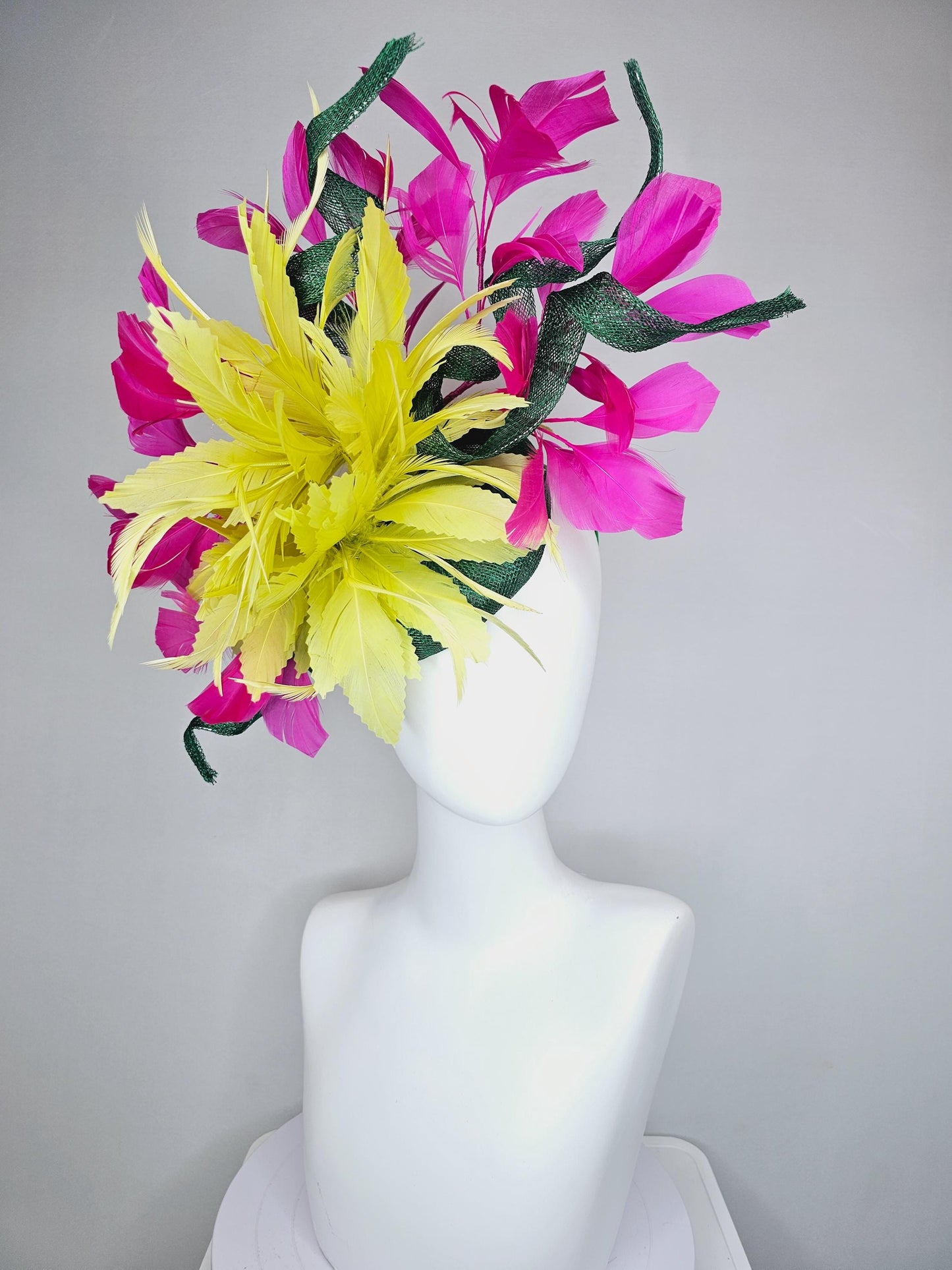 kentucky derby hat fascinator dark green sinamay with curls and fluffy yellow zigzag feather flower, bright pink fuchsia branching feathers