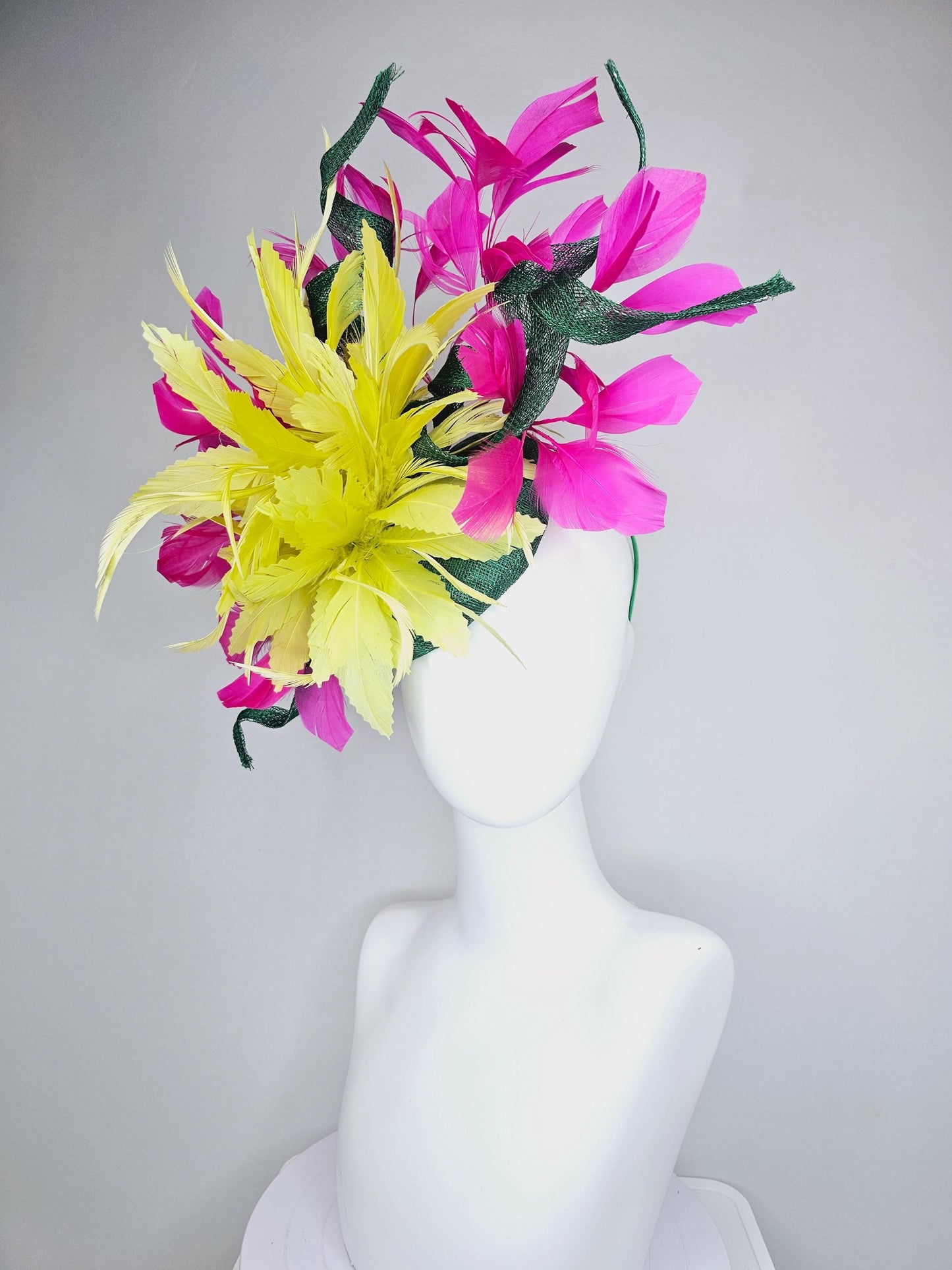 kentucky derby hat fascinator dark green sinamay with curls and fluffy yellow zigzag feather flower, bright pink fuchsia branching feathers