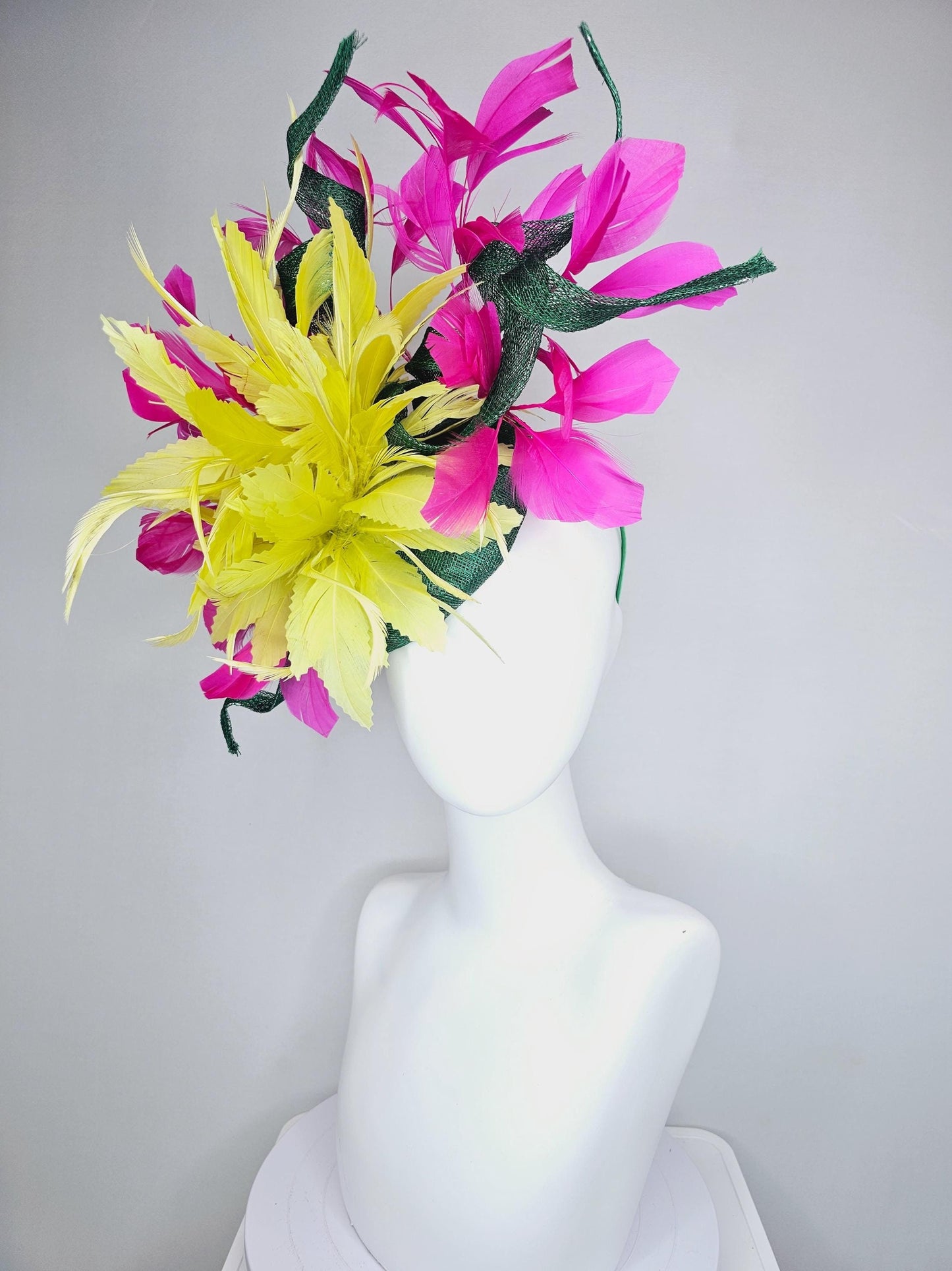 kentucky derby hat fascinator dark green sinamay with curls and fluffy yellow zigzag feather flower, bright pink fuchsia branching feathers