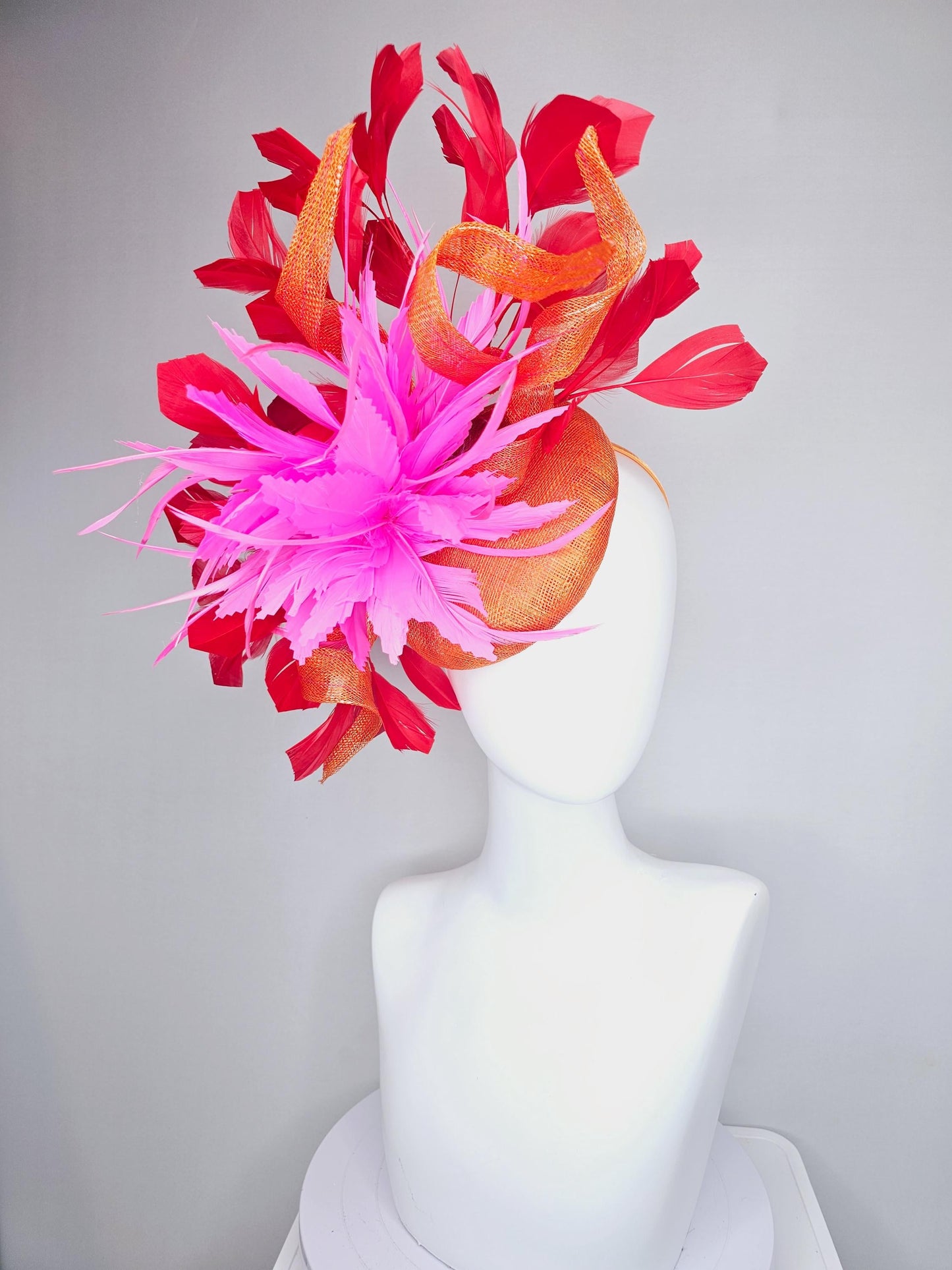 kentucky derby hat fascinator orange sinamay with curls and fluffy zigzag bright pink feather flower, red branching feathers