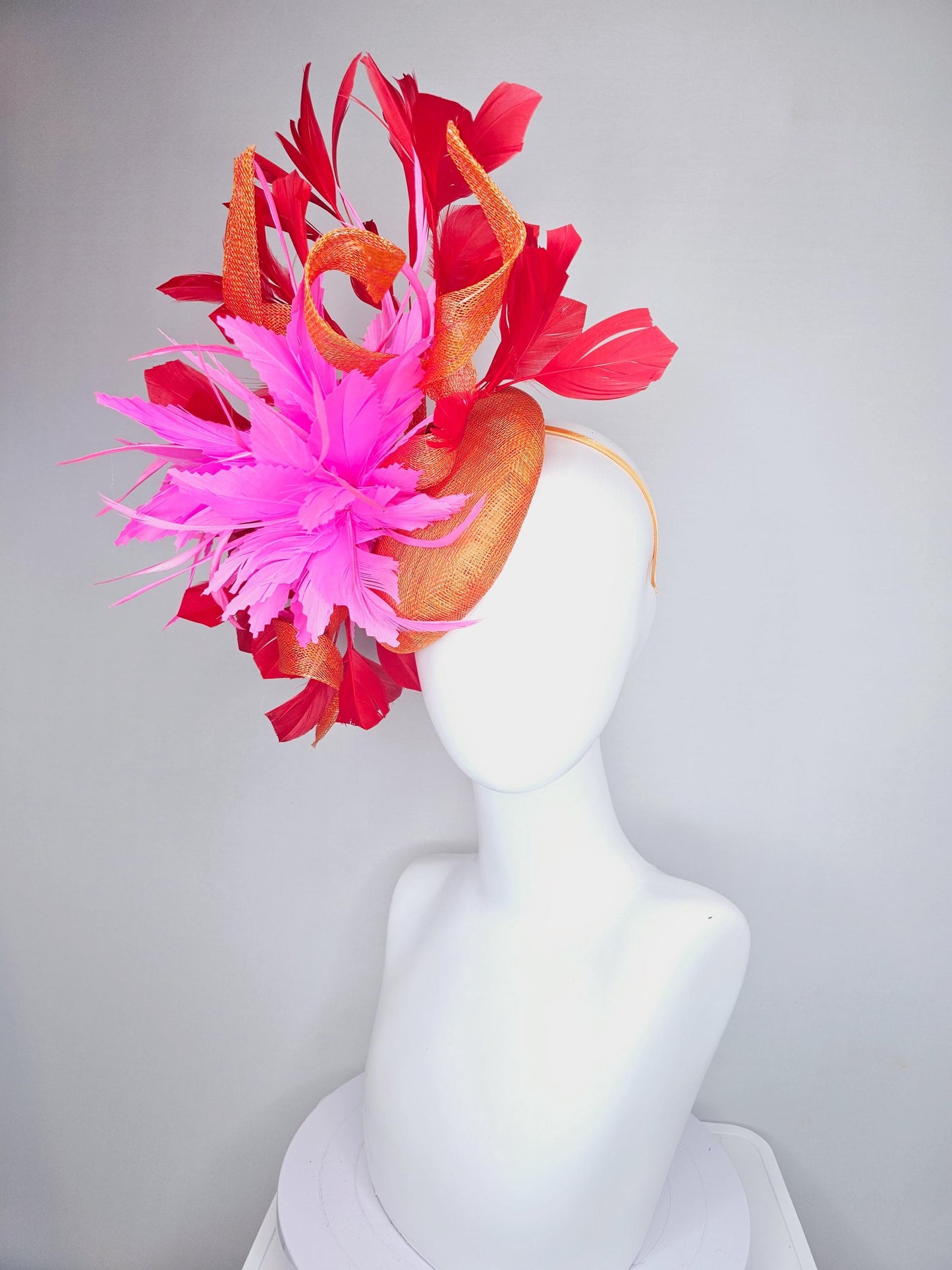 kentucky derby hat fascinator orange sinamay with curls and fluffy zigzag bright pink feather flower, red branching feathers