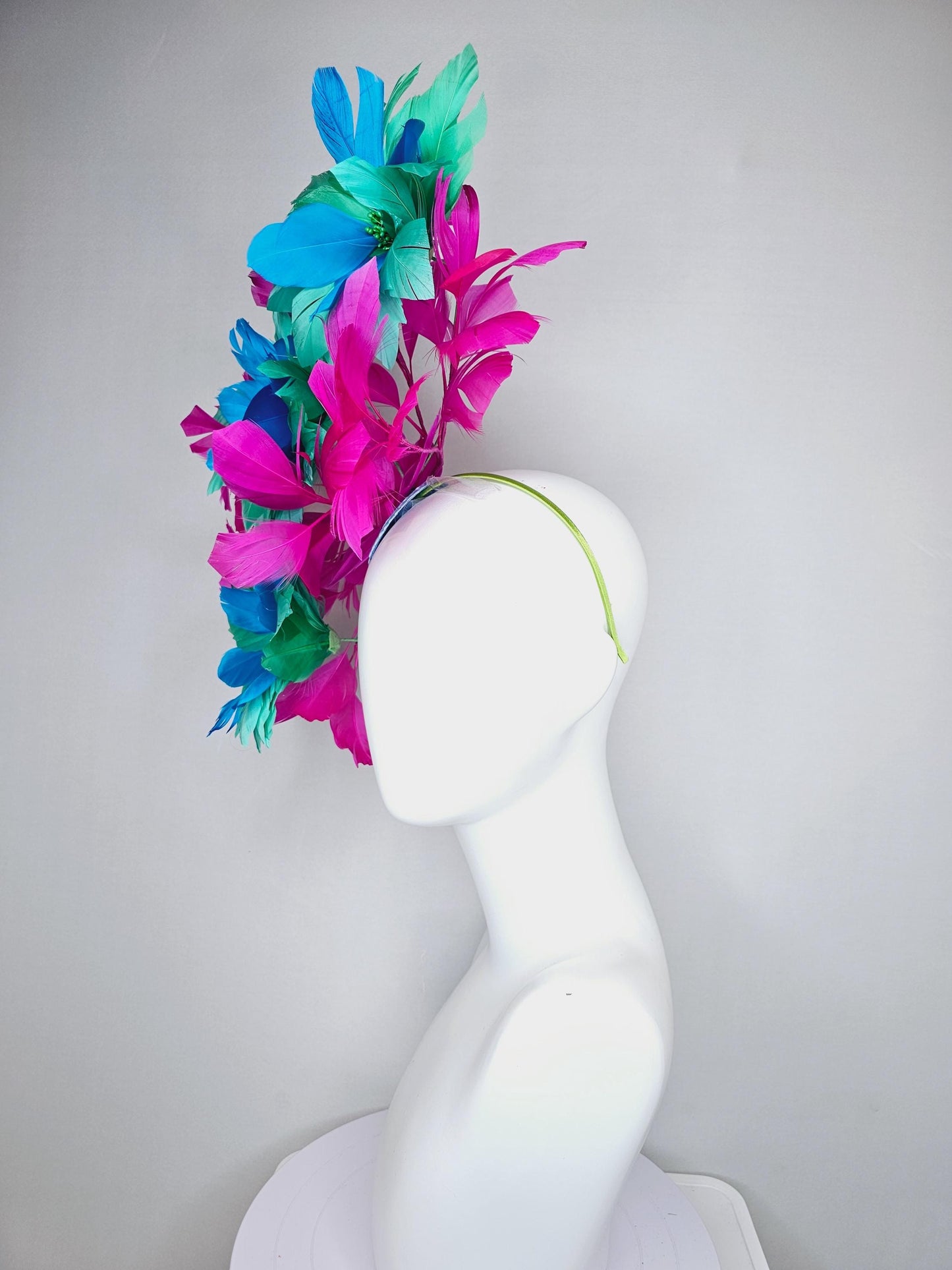 kentucky derby hat fascinator with large mint green sky blue feather flowers and bright fuchsia pink branching feathers