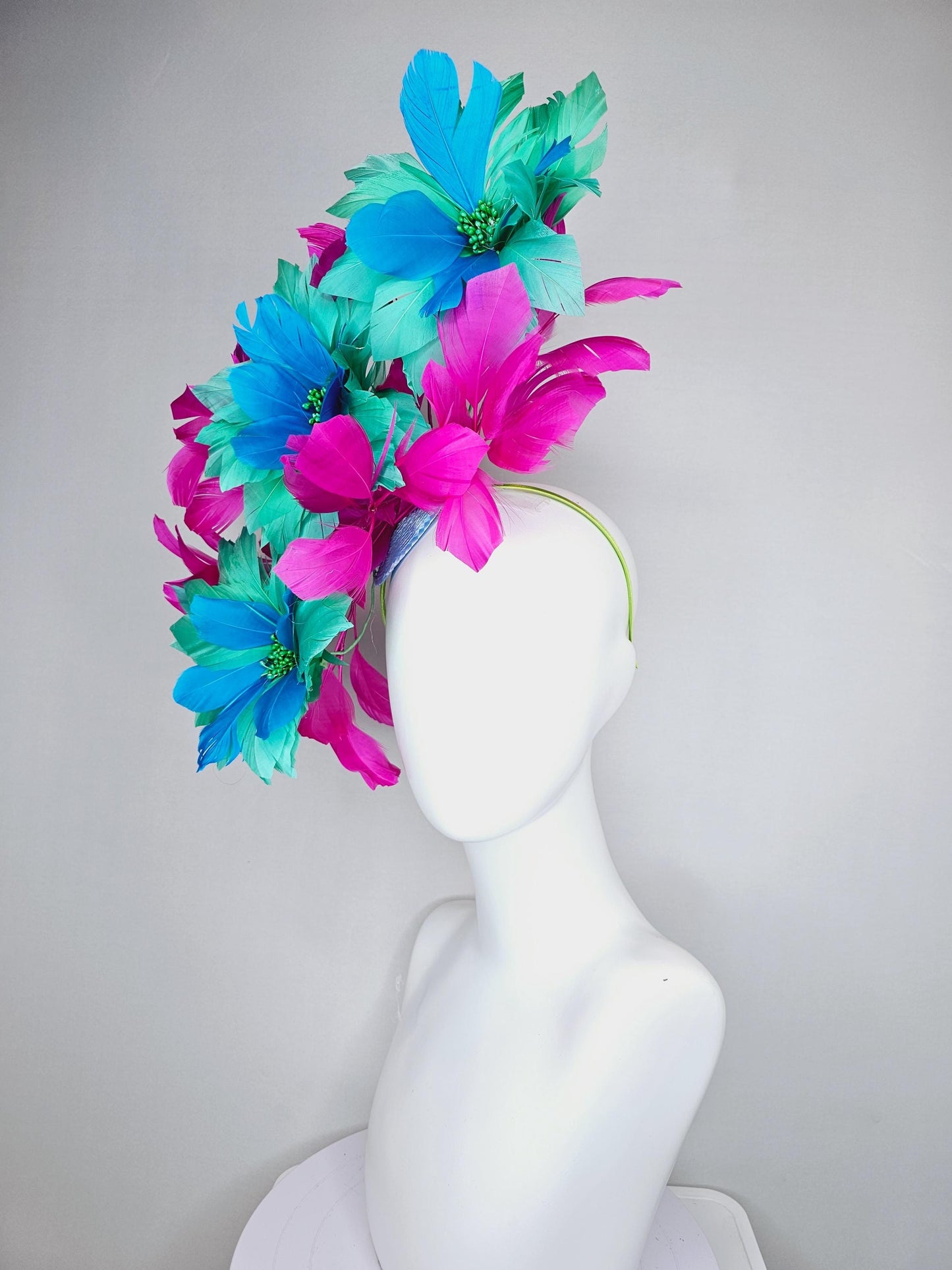 kentucky derby hat fascinator with large mint green sky blue feather flowers and bright fuchsia pink branching feathers