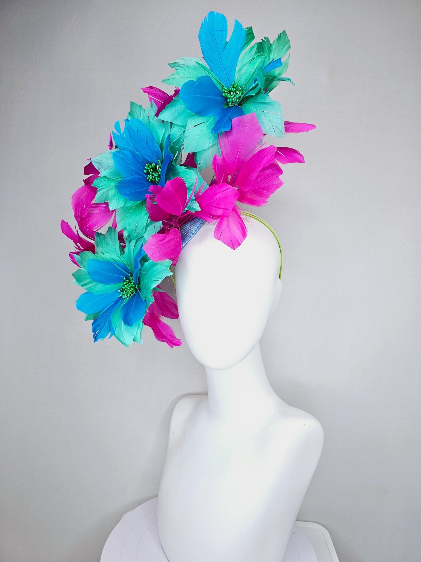 kentucky derby hat fascinator with large mint green sky blue feather flowers and bright fuchsia pink branching feathers