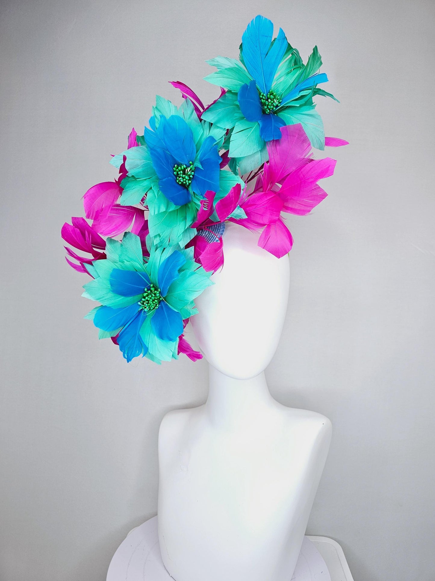 kentucky derby hat fascinator with large mint green sky blue feather flowers and bright fuchsia pink branching feathers