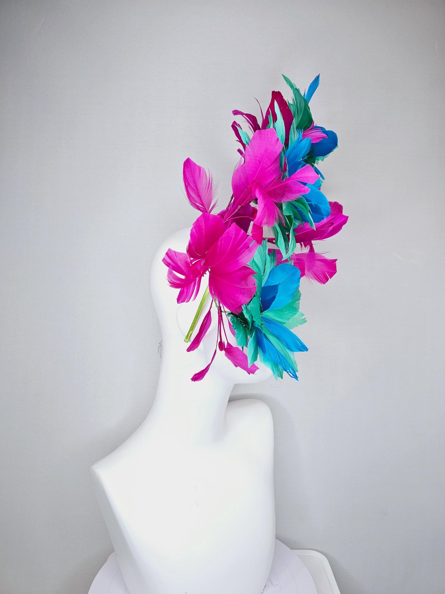 kentucky derby hat fascinator with large mint green sky blue feather flowers and bright fuchsia pink branching feathers