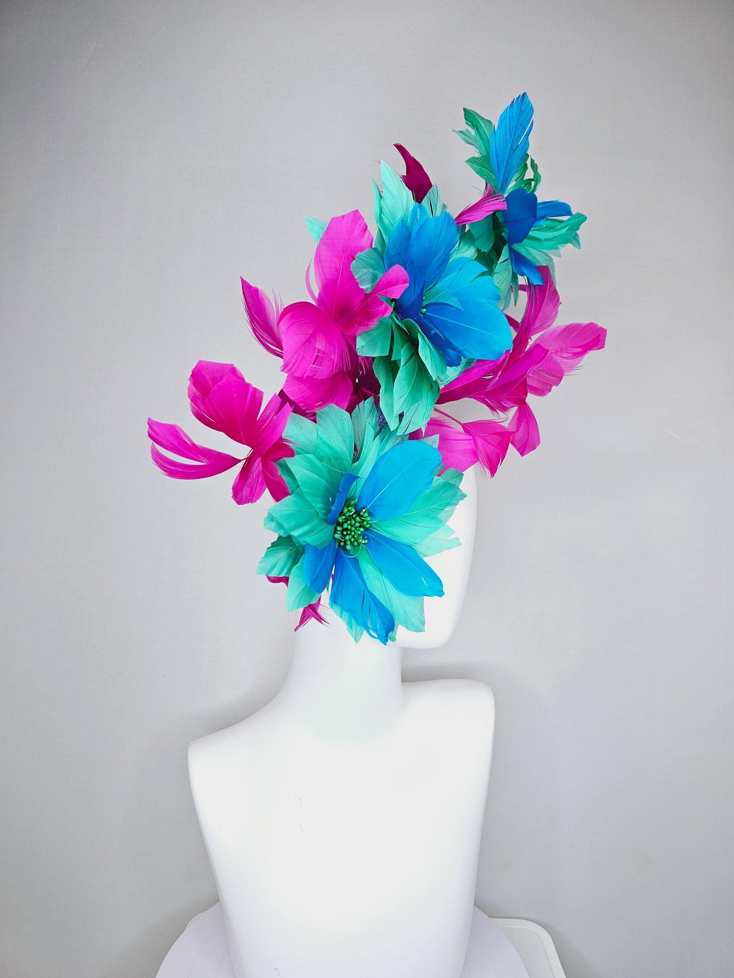 kentucky derby hat fascinator with large mint green sky blue feather flowers and bright fuchsia pink branching feathers