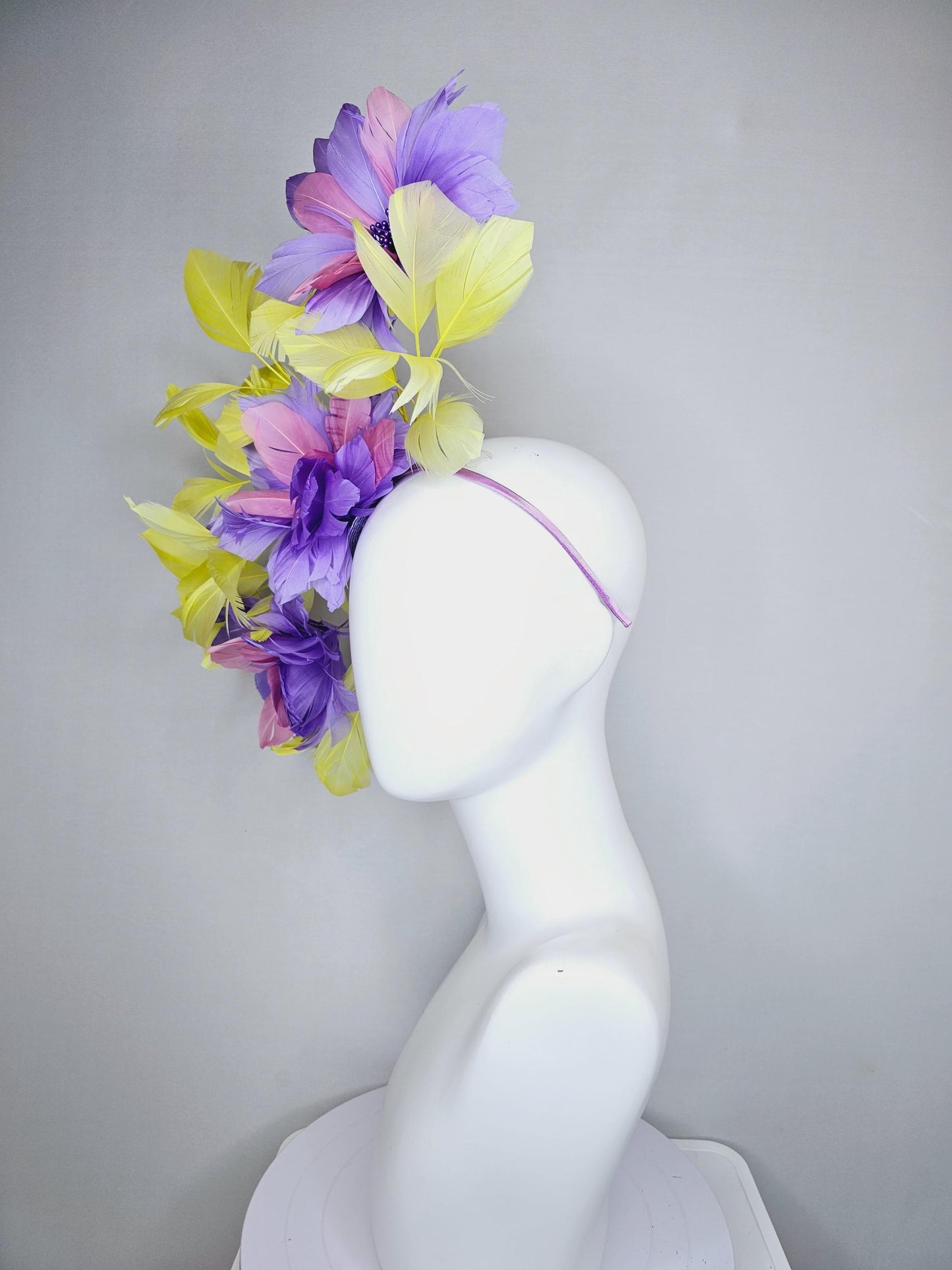 kentucky derby hat fascinator with large lavender purple light pink feather flowers and yellow branching feathers