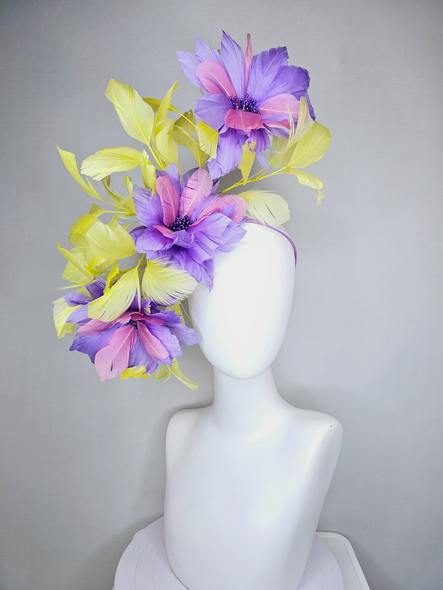 kentucky derby hat fascinator with large lavender purple light pink feather flowers and yellow branching feathers