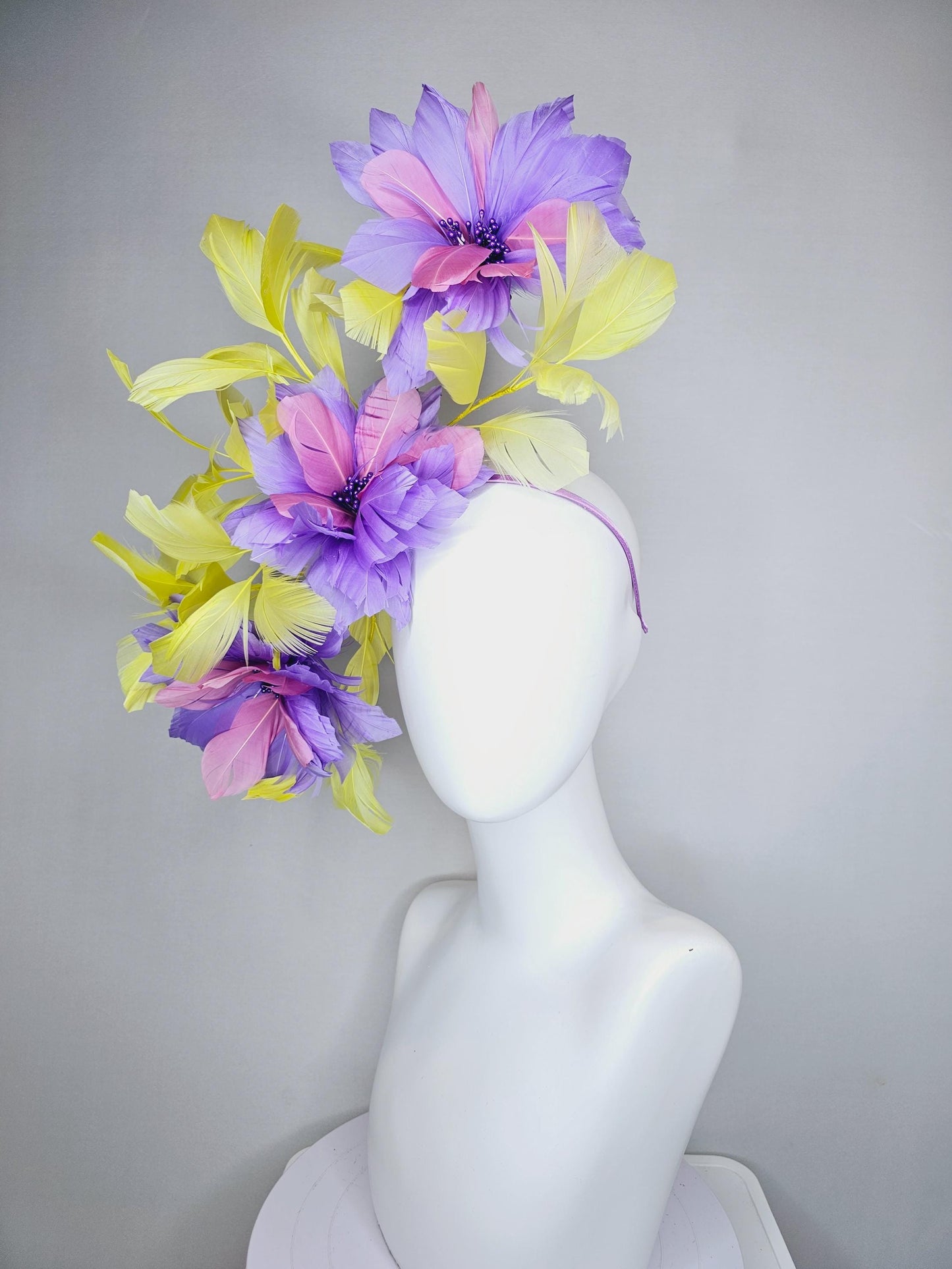 kentucky derby hat fascinator with large lavender purple light pink feather flowers and yellow branching feathers