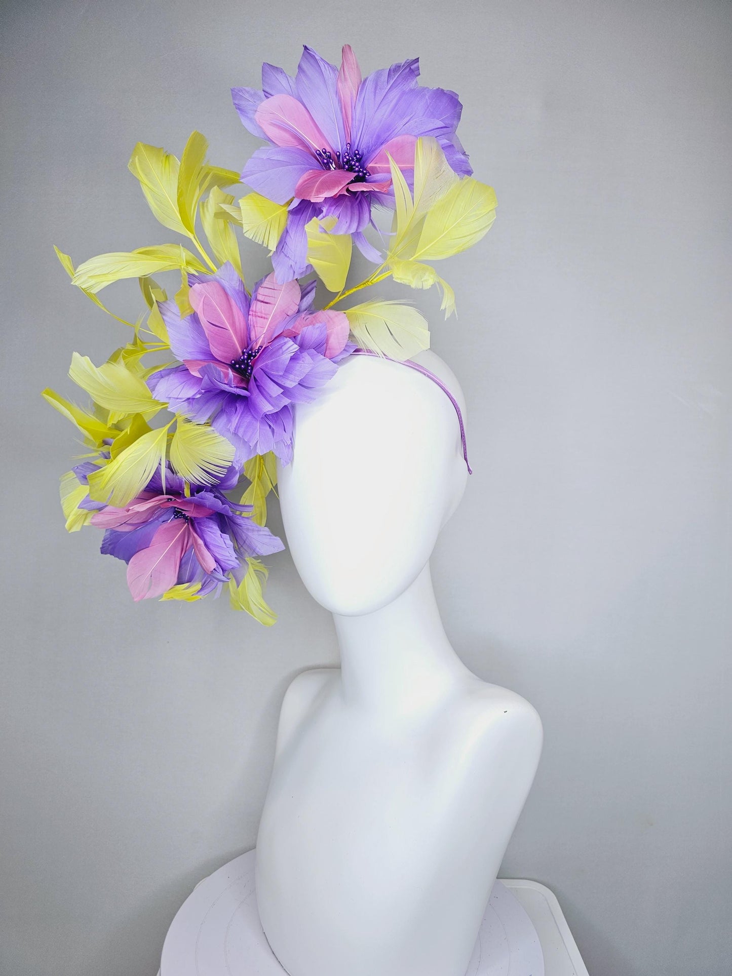 kentucky derby hat fascinator with large lavender purple light pink feather flowers and yellow branching feathers