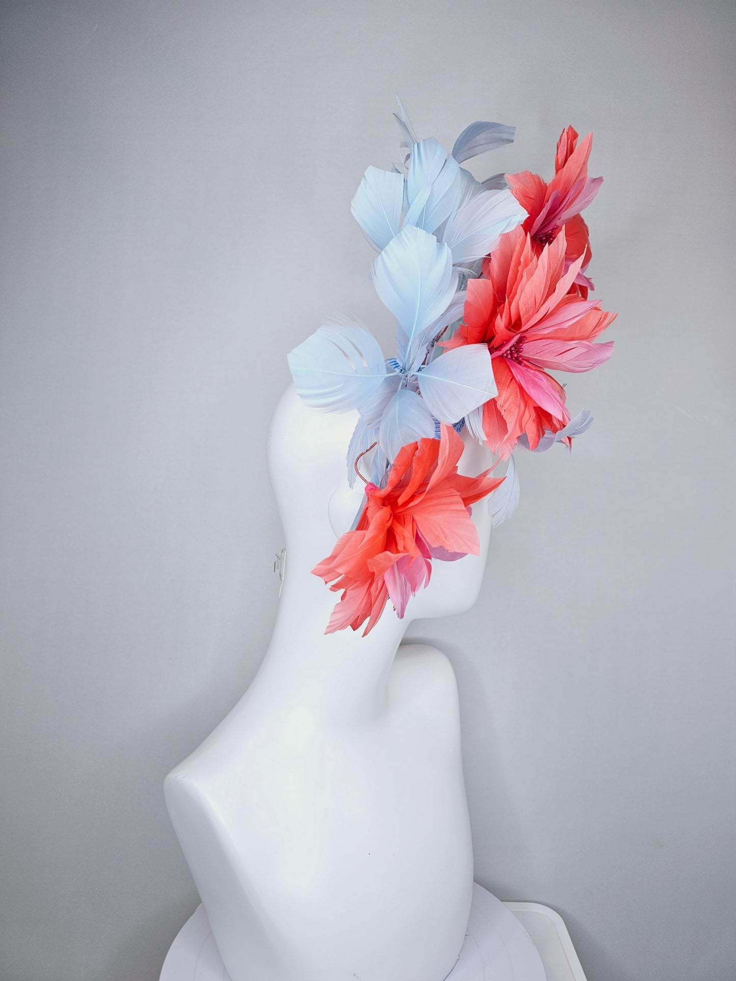 kentucky derby hat fascinator with large coral orange light pink feather flowers and light baby blue branching feathers