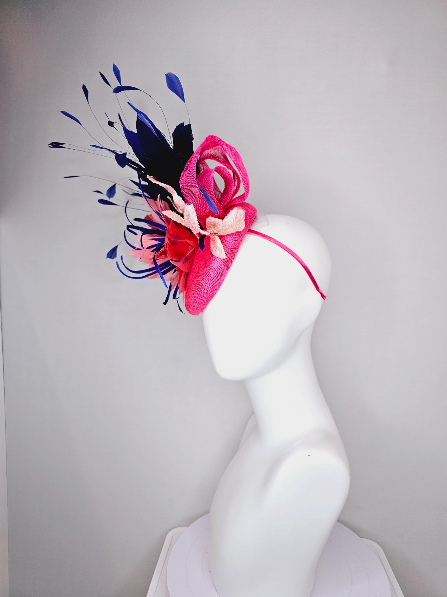 kentucky derby hat fascinator raspberry pink sinamay with peach pink and royal blue feather flower,peach leaves,navy blue branching feathers