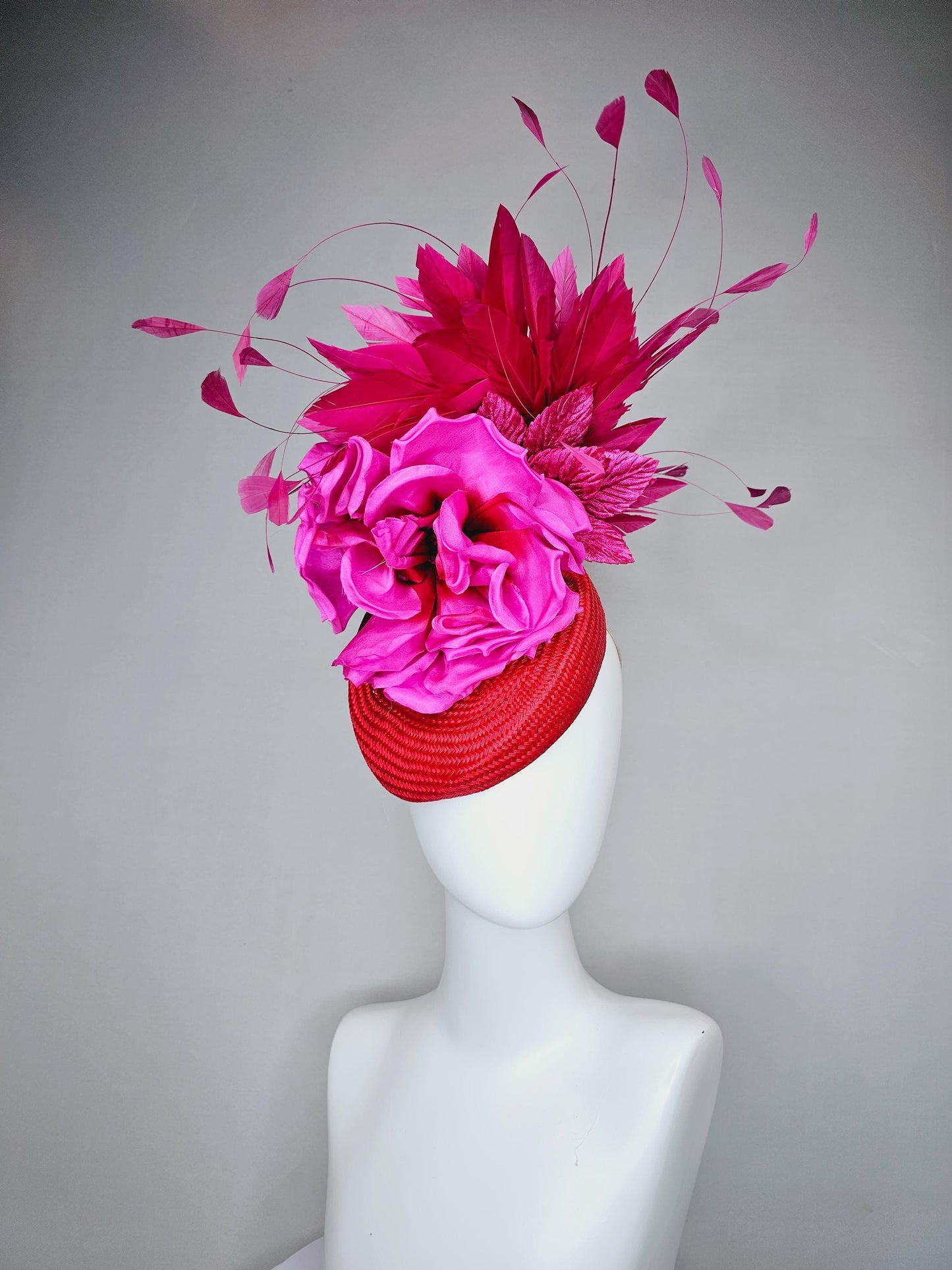 kentucky derby hat fascinator bright red woven base with large fuchsia pink satin silk rose flower and hot pink branching feathers