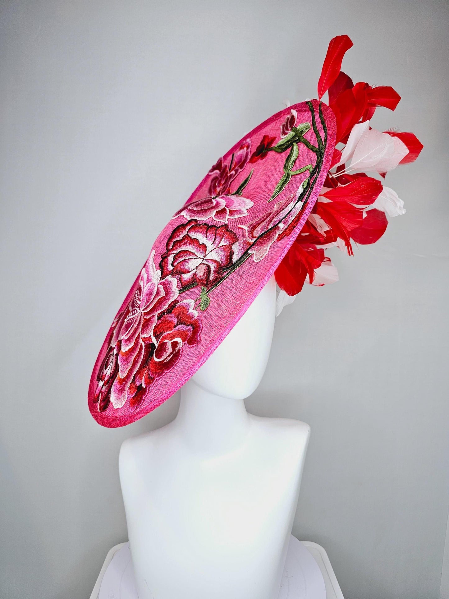 kentucky derby hat fascinator hot pink large saucer with red,pink,white embroidered flowers,green leaves,red and white branching feathers