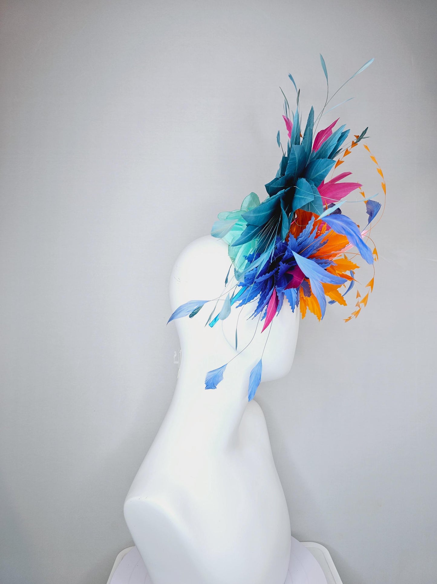 kentucky derby hat fascinator tangerine orange feather flower with colorful pink,blue teal,and cobalt blue branching feathers