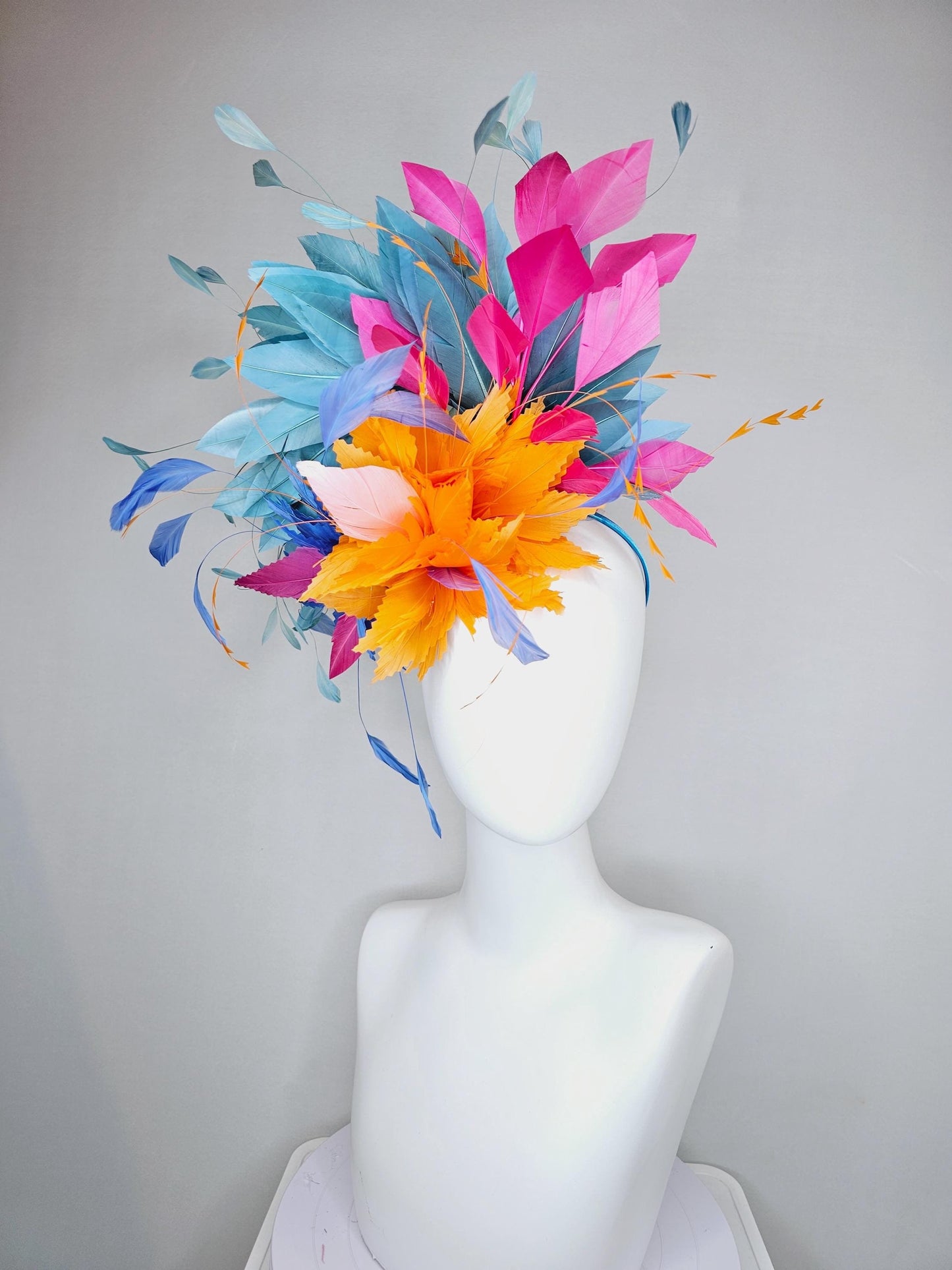 kentucky derby hat fascinator tangerine orange feather flower with colorful pink,blue teal,and cobalt blue branching feathers