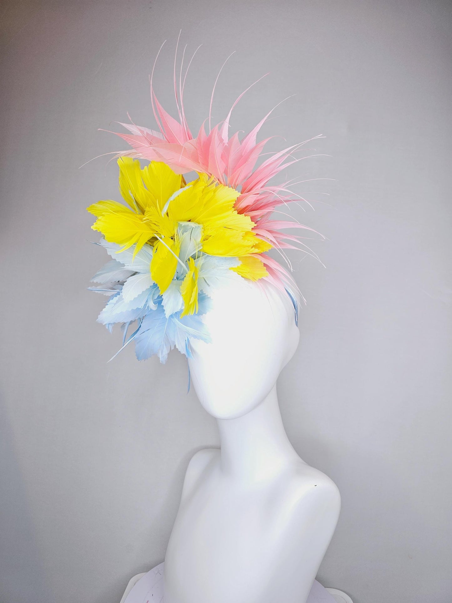 kentucky derby hat fascinator light blue fluffy zigzag feather flower with bright yellow branching feathers and light pink pointy feathers