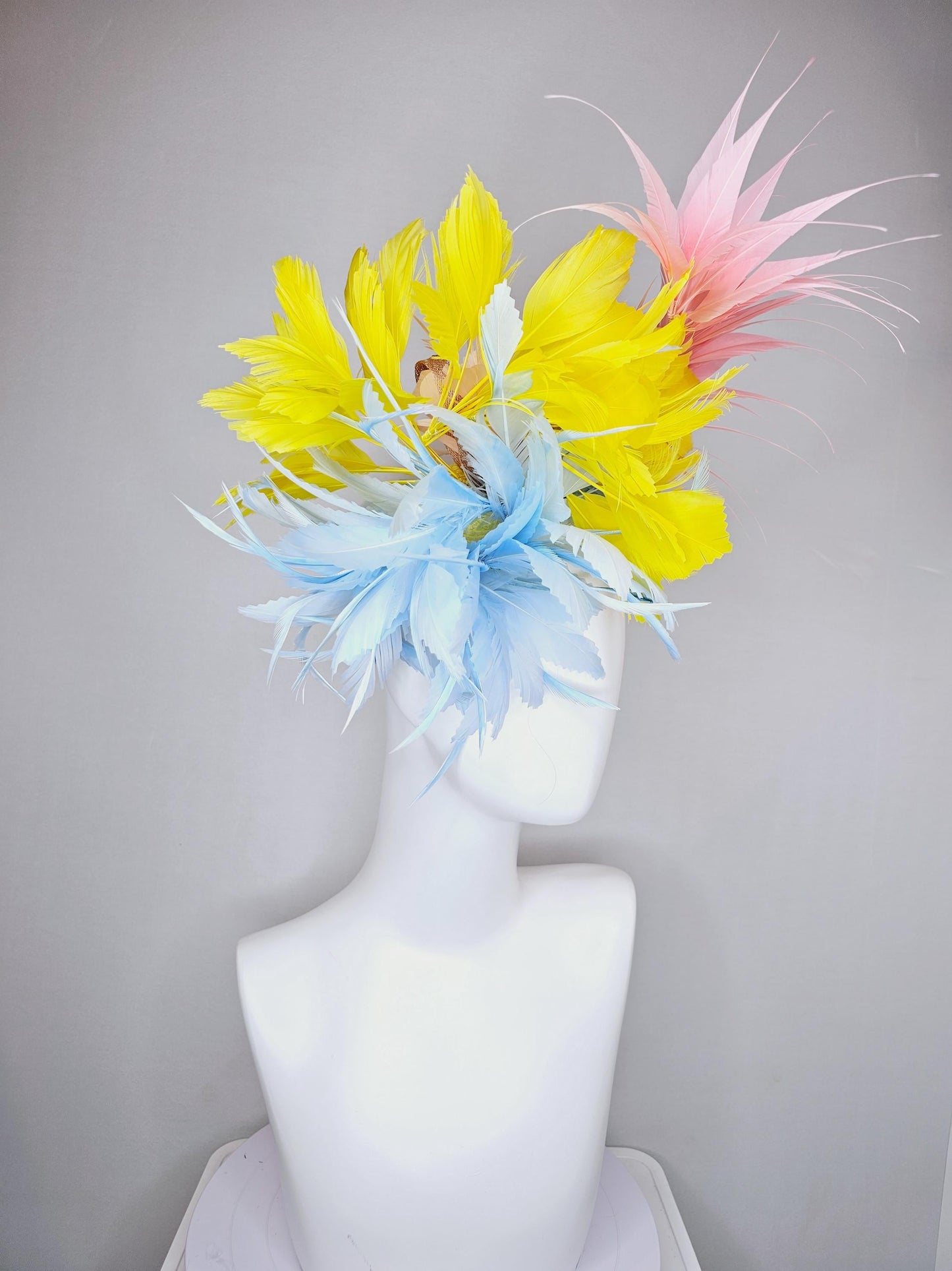 kentucky derby hat fascinator light blue fluffy zigzag feather flower with bright yellow branching feathers and light pink pointy feathers