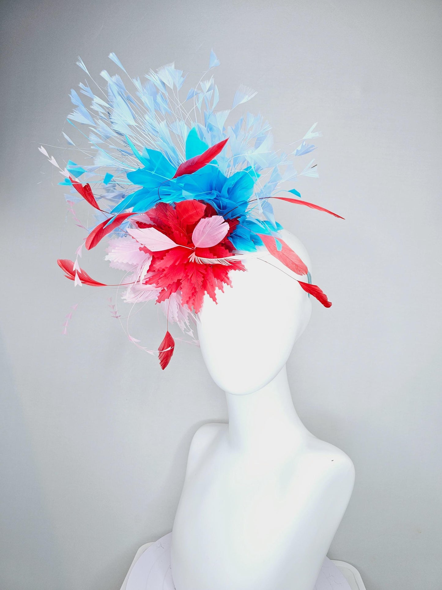 kentucky derby hat fascinator light pink and cherry red zigzag feather flowers with bright sky blue and light blue branching feathers