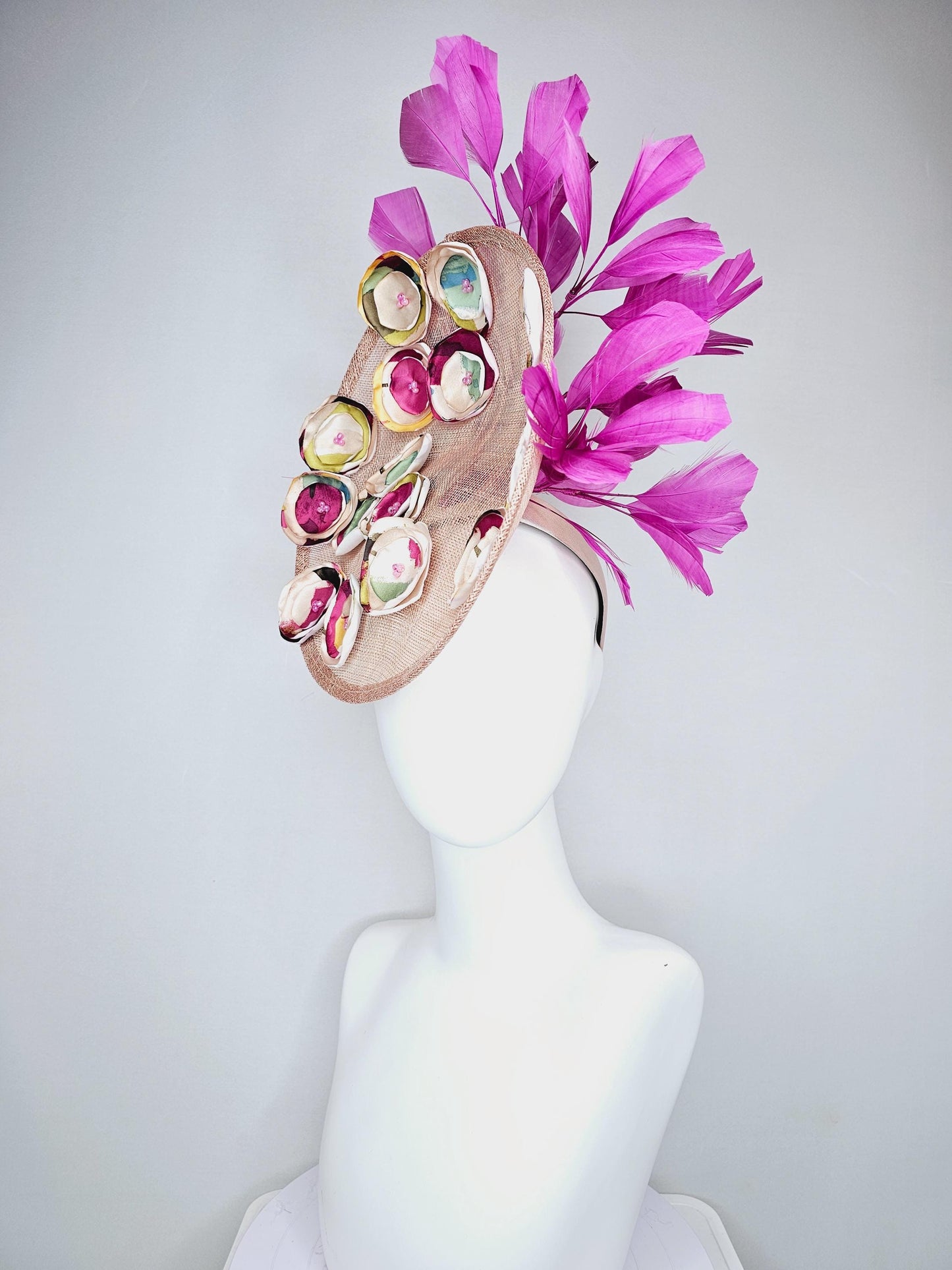 kentucky derby hat fascinator dusty pink champagne sinamay saucer with burgundy red yellow blue green satin flowers, magenta pink feathers