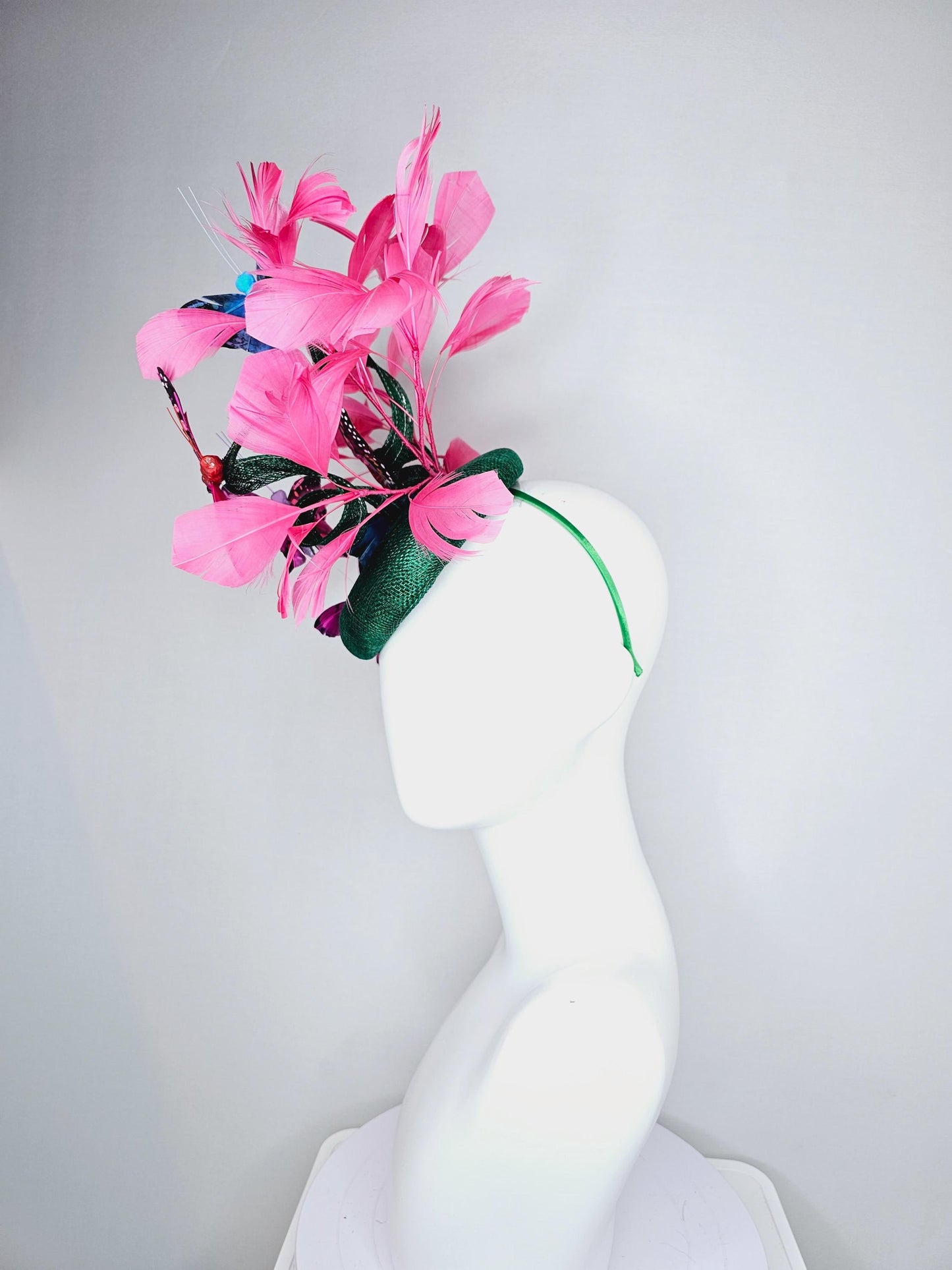 kentucky derby hat fascinator dark green sinamay with curls,pink branching feathers,colorful rainbow blue,pink,purple painted butterflies