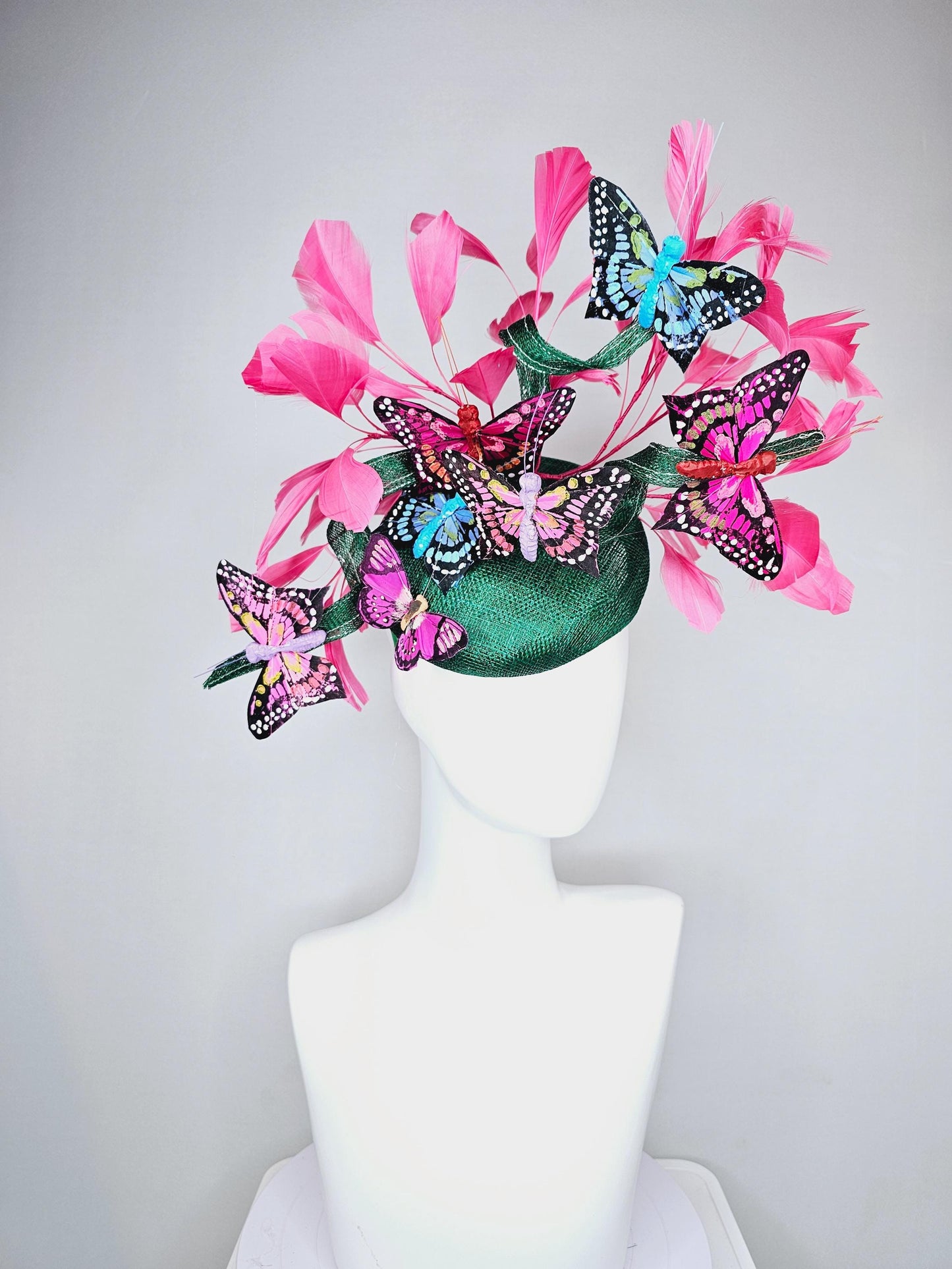 kentucky derby hat fascinator dark green sinamay with curls,pink branching feathers,colorful rainbow blue,pink,purple painted butterflies