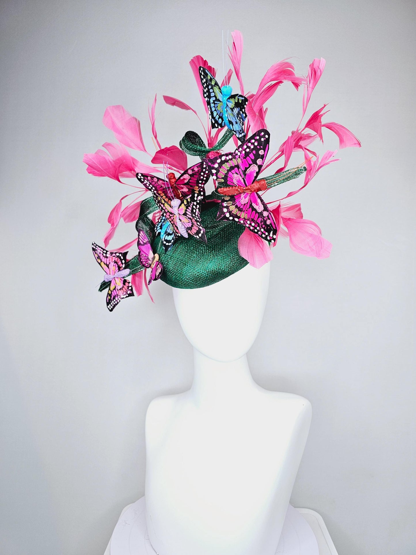 kentucky derby hat fascinator dark green sinamay with curls,pink branching feathers,colorful rainbow blue,pink,purple painted butterflies