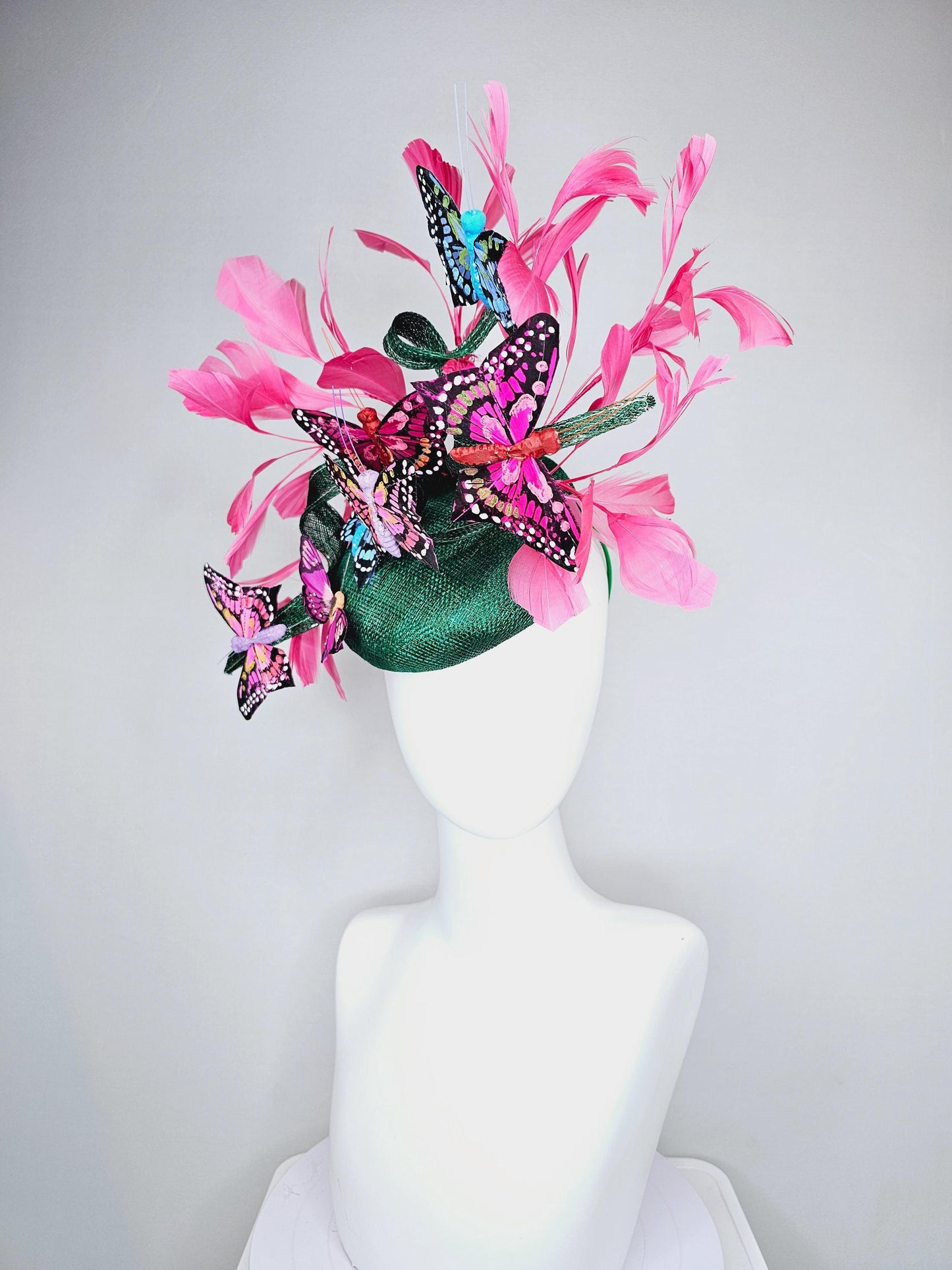 kentucky derby hat fascinator dark green sinamay with curls,pink branching feathers,colorful rainbow blue,pink,purple painted butterflies