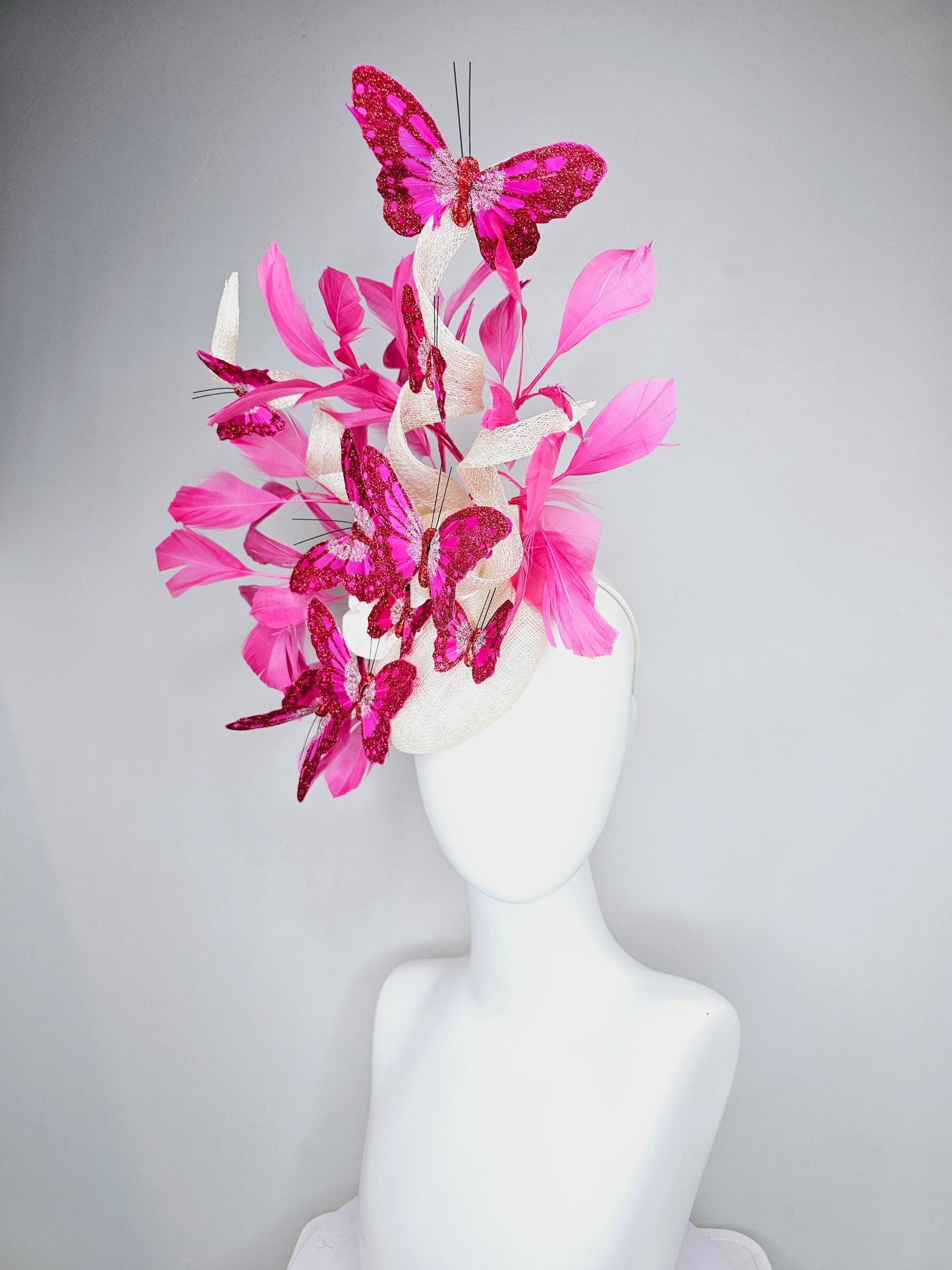 kentucky derby hat fascinator white sinamay with tall curls,pink branching feathers,pink fuchsia glitter sparkle large butterflies