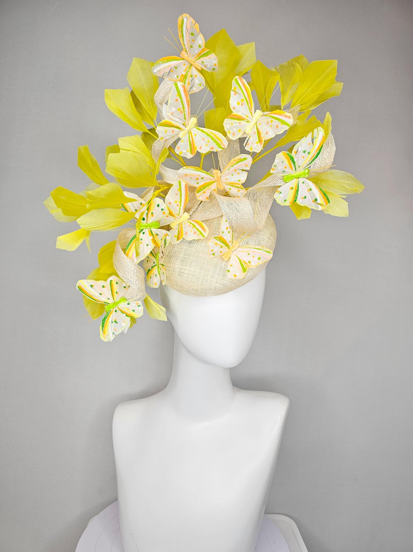 kentucky derby hat fascinator white sinamay with large curls,yellow branching feathers and green,yellow,orange dotted feather butterflies