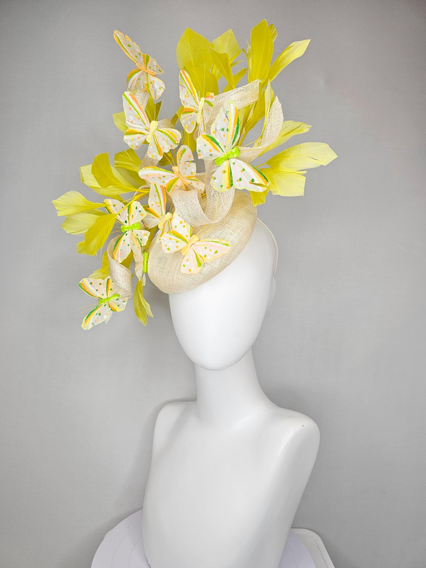 kentucky derby hat fascinator white sinamay with large curls,yellow branching feathers and green,yellow,orange dotted feather butterflies