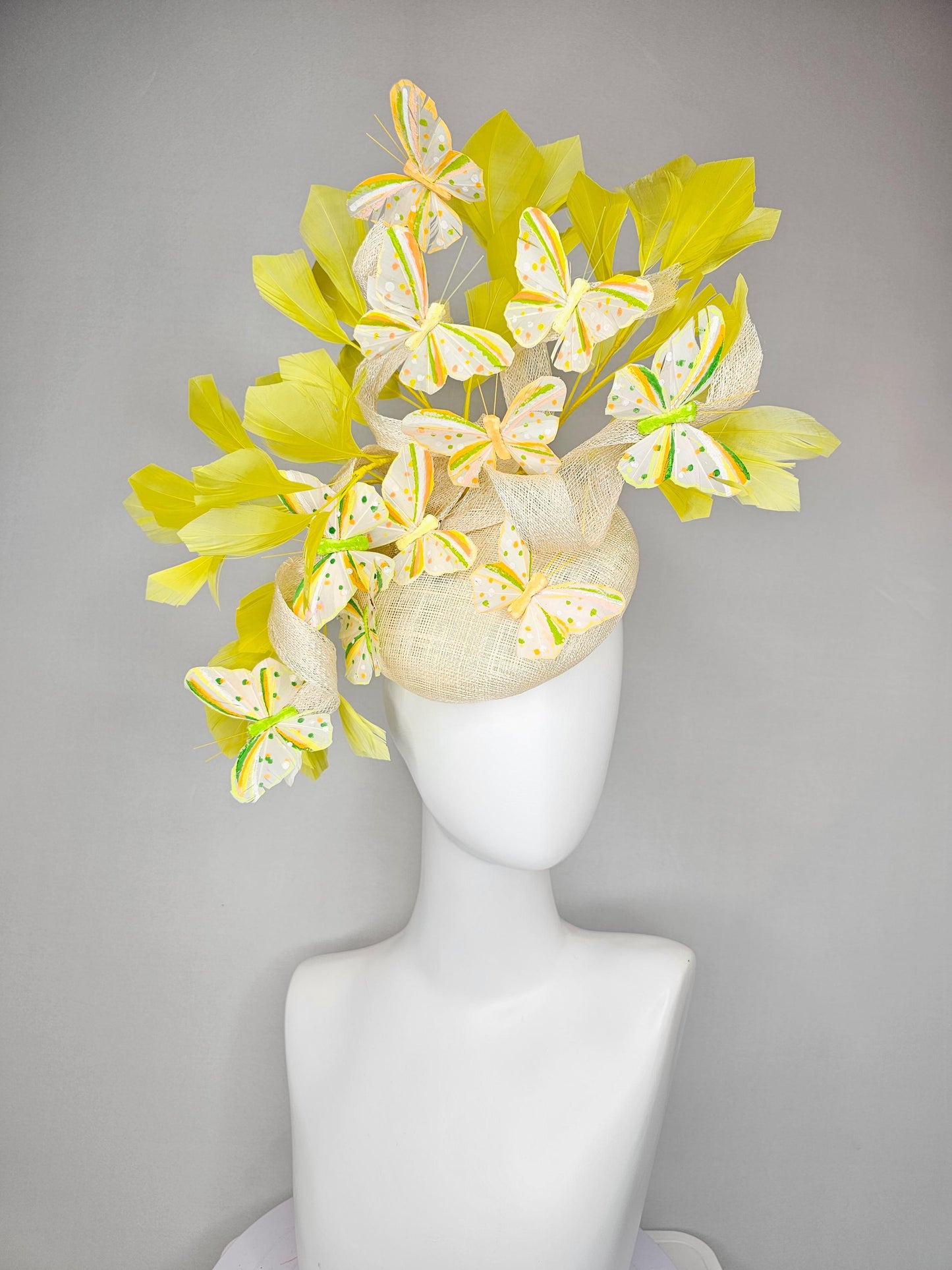 kentucky derby hat fascinator white sinamay with large curls,yellow branching feathers and green,yellow,orange dotted feather butterflies