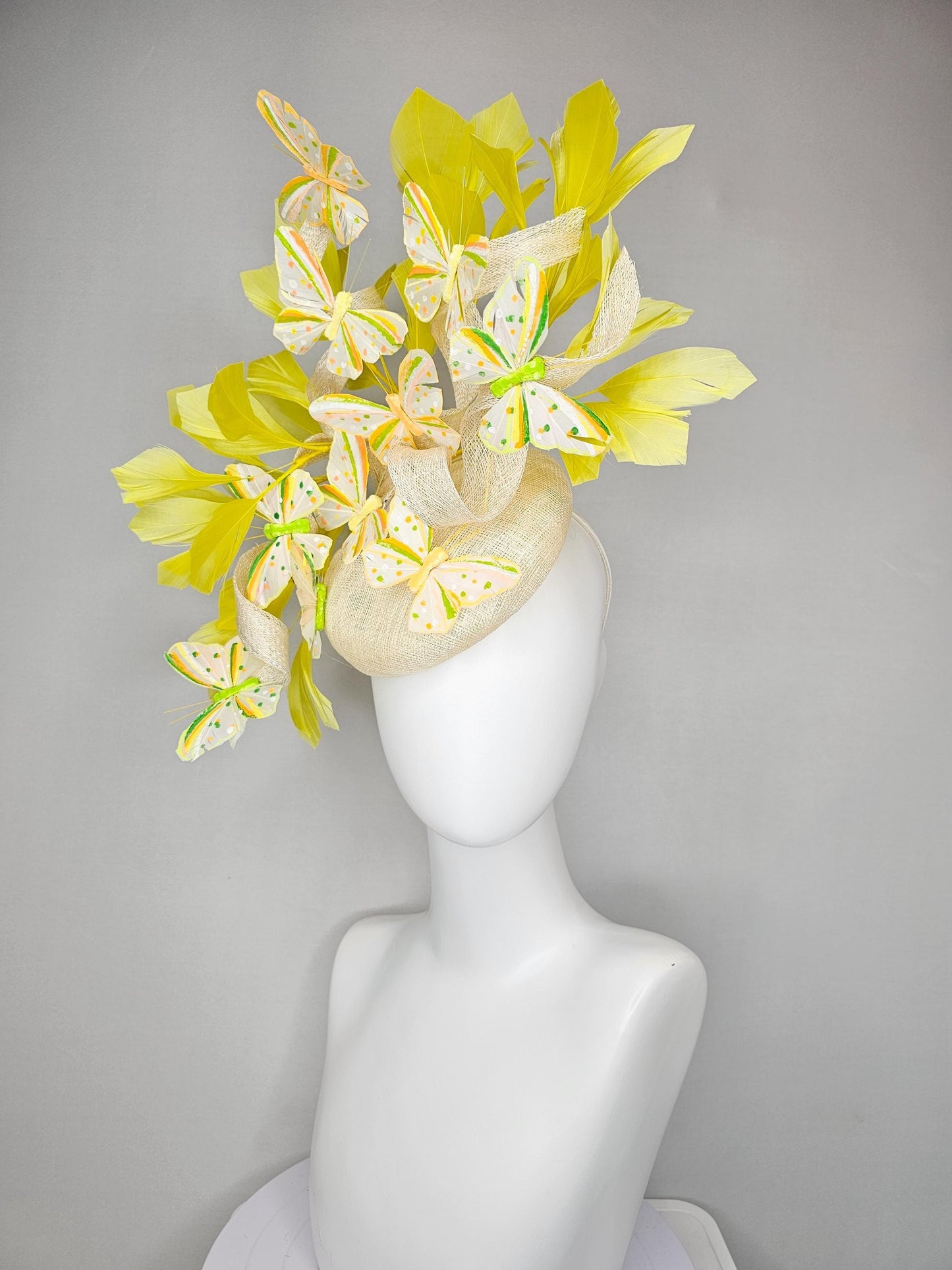 kentucky derby hat fascinator white sinamay with large curls,yellow branching feathers and green,yellow,orange dotted feather butterflies