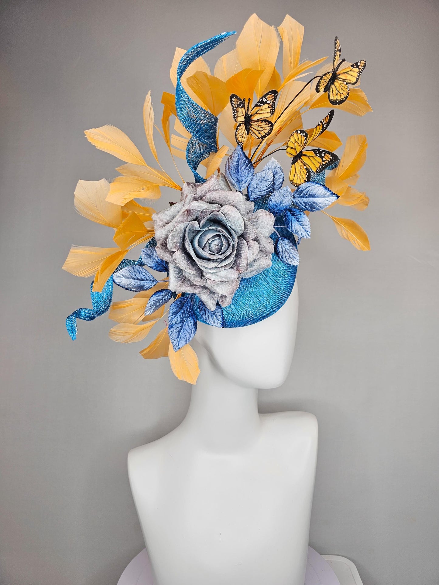 kentucky derby hat fascinator blue sinamay w/ curls,blue purple ombre rose,blue leaves,apricot orange yellow feathers w/ apricot butterflies