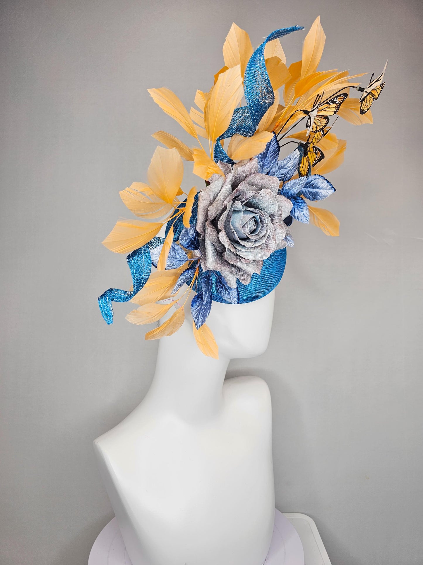 kentucky derby hat fascinator blue sinamay w/ curls,blue purple ombre rose,blue leaves,apricot orange yellow feathers w/ apricot butterflies