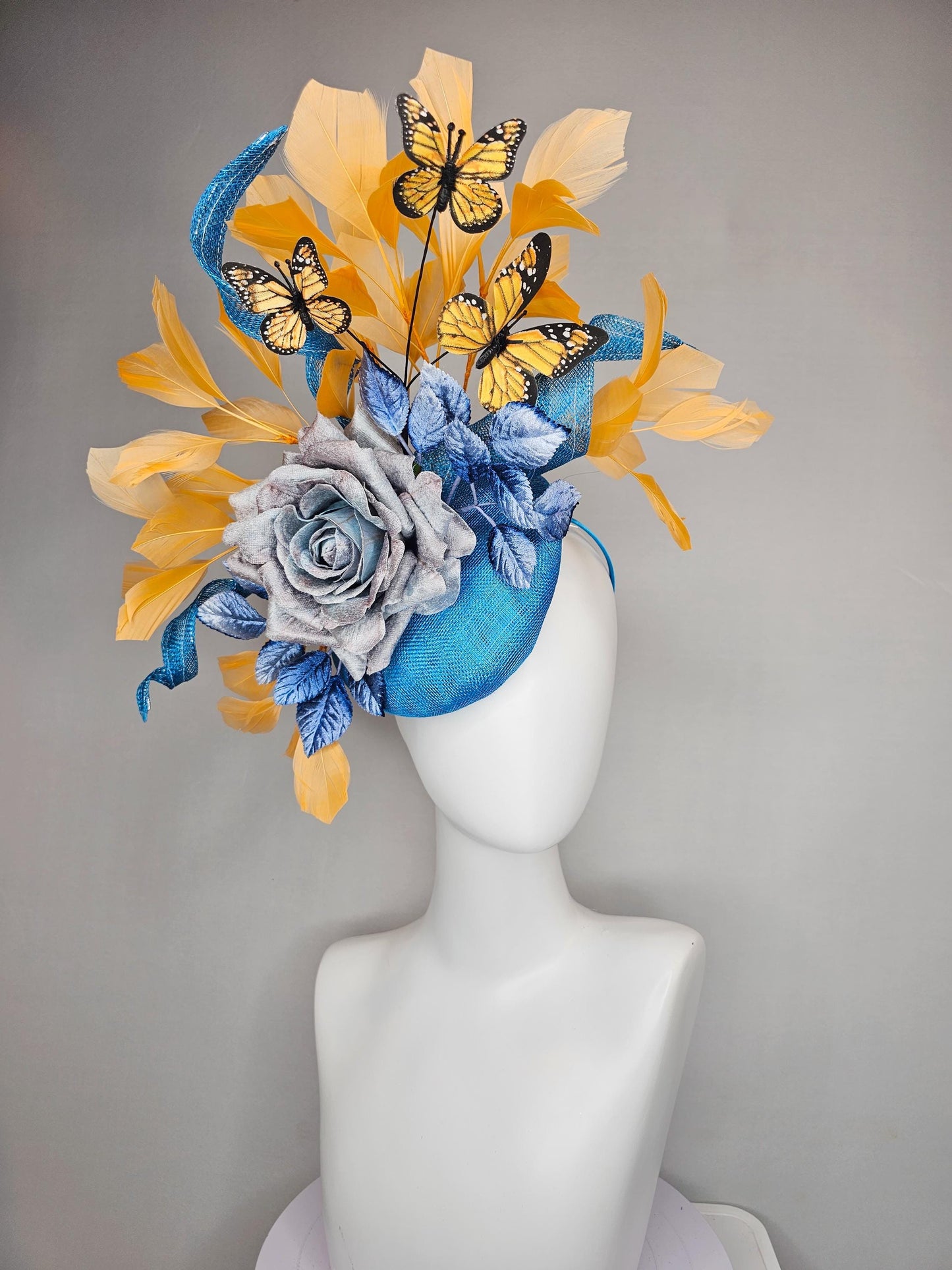 kentucky derby hat fascinator blue sinamay w/ curls,blue purple ombre rose,blue leaves,apricot orange yellow feathers w/ apricot butterflies