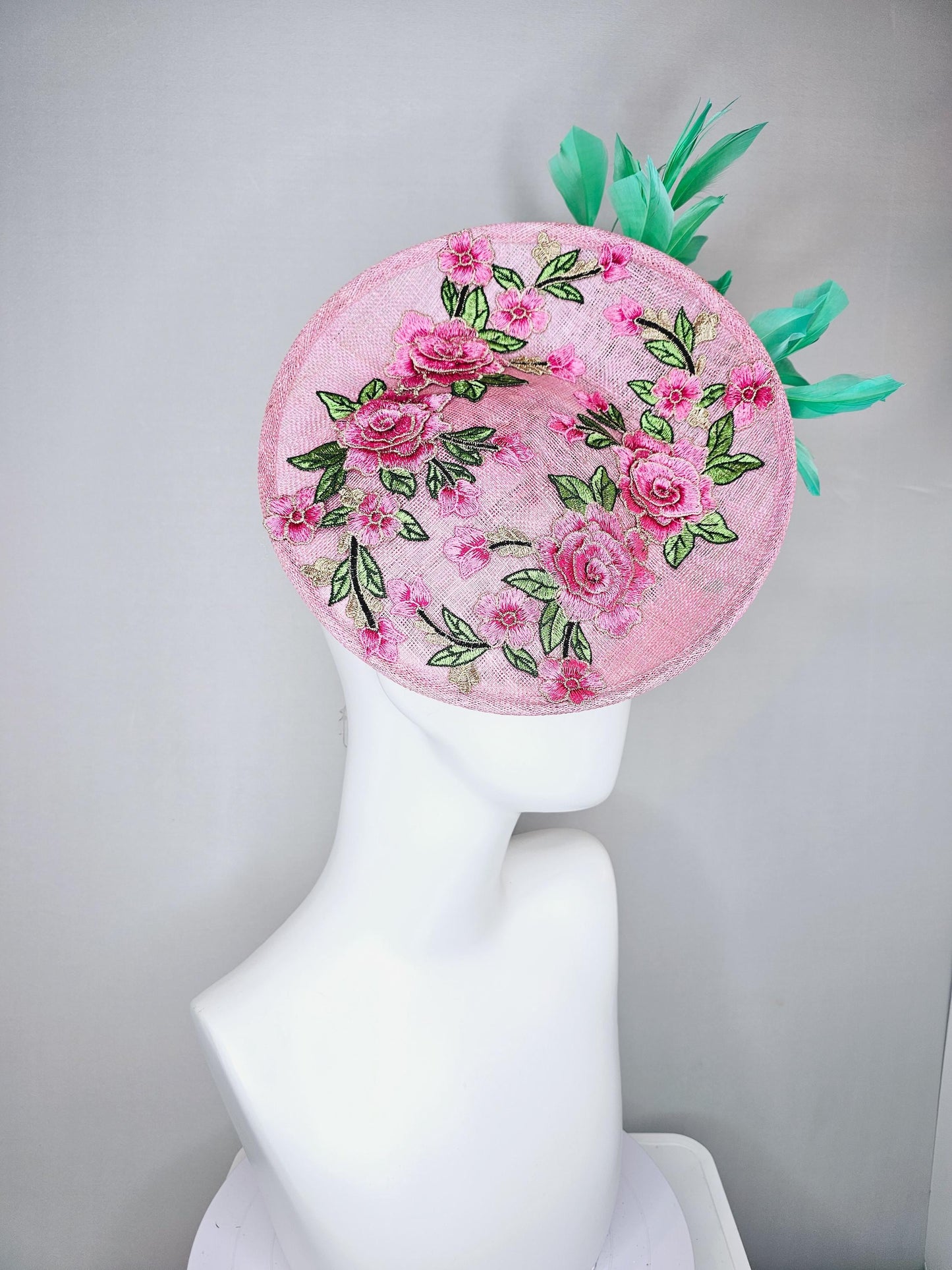 kentucky derby hat fascinator light pink sinamay saucer with pink flowers green leaves embroidered and aqua mint green branching feathers