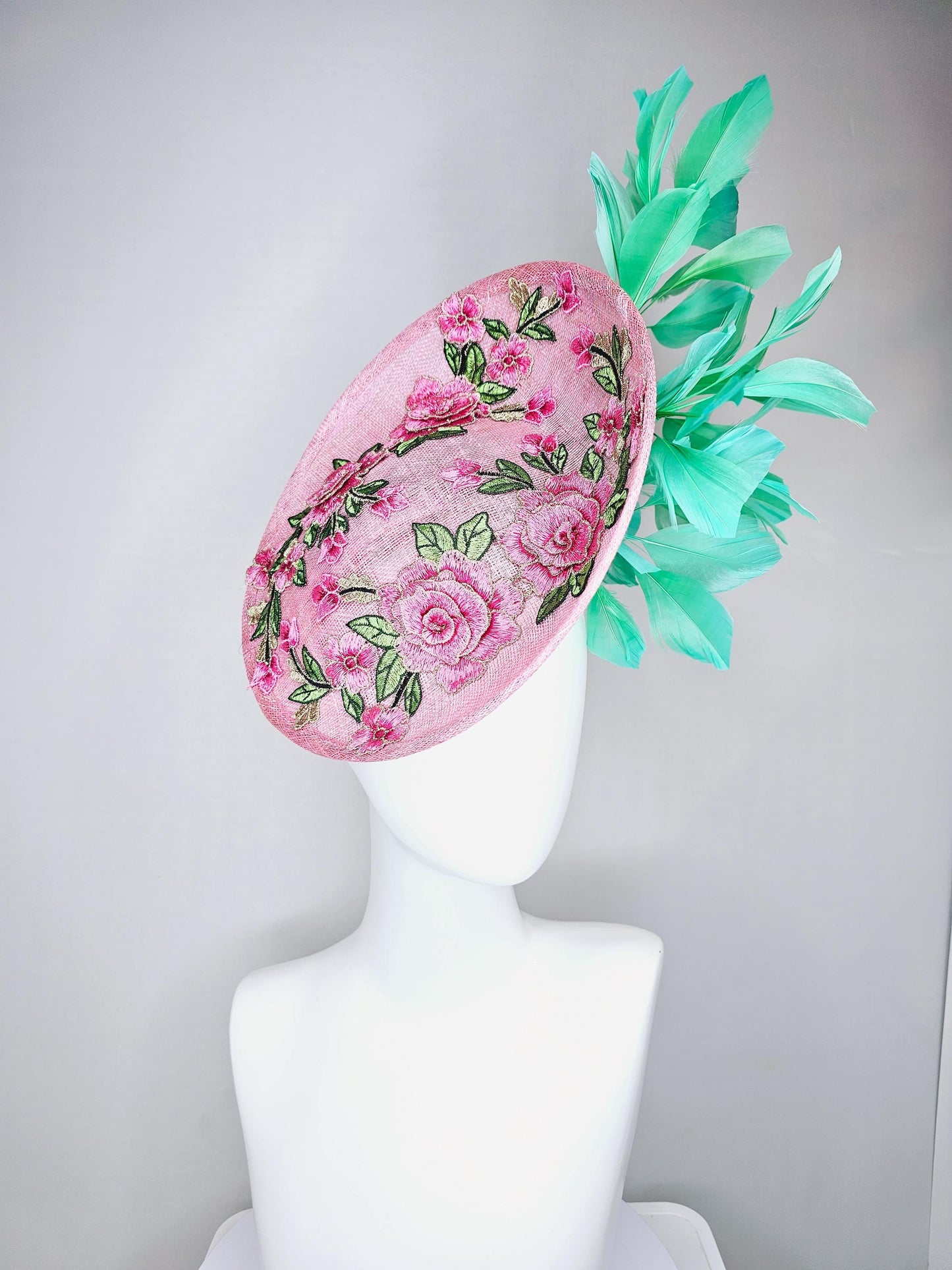 kentucky derby hat fascinator light pink sinamay saucer with pink flowers green leaves embroidered and aqua mint green branching feathers