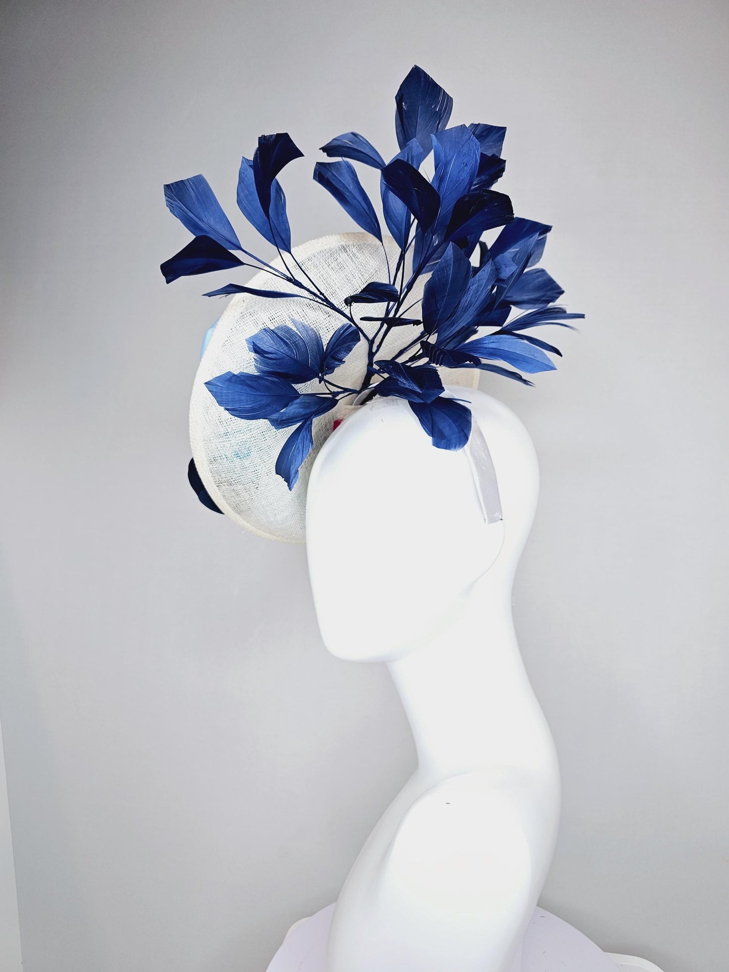 kentucky derby hat fascinator white sinamay saucer with light blue sky blue navy blue satin silk flowers and navy blue branching feathers