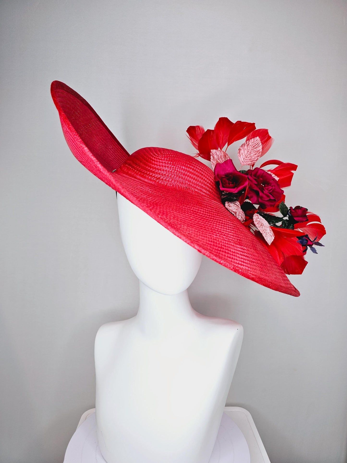 kentucky derby hat wide brim straw in red with scarlet red branching feathers with burgundy red satin roses and light pink dark green leaves