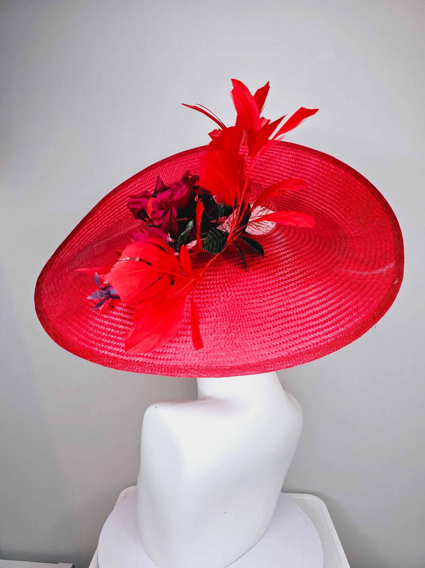 kentucky derby hat wide brim straw in red with scarlet red branching feathers with burgundy red satin roses and light pink dark green leaves