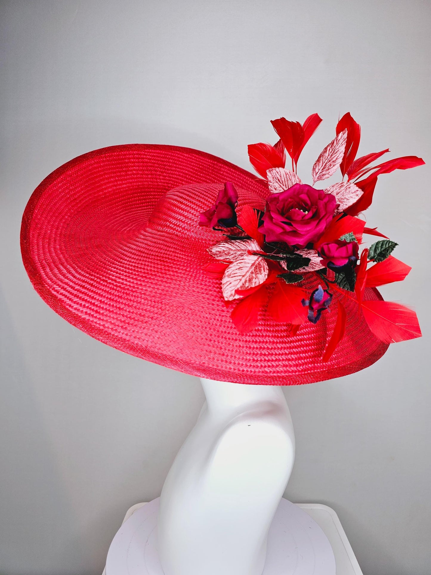 kentucky derby hat wide brim straw in red with scarlet red branching feathers with burgundy red satin roses and light pink dark green leaves
