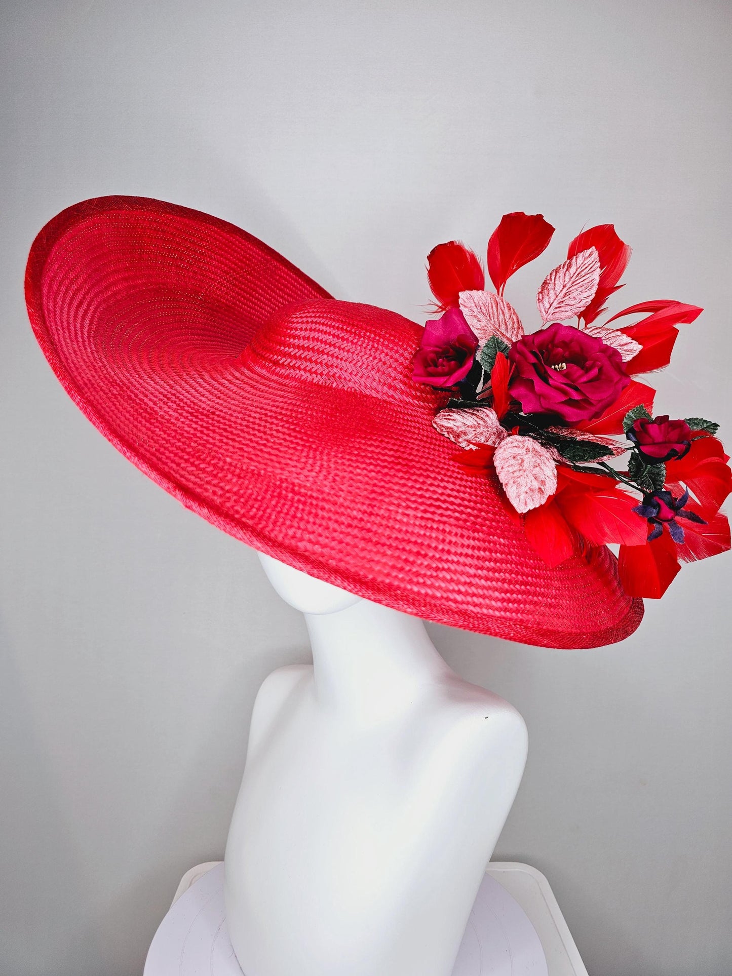 kentucky derby hat wide brim straw in red with scarlet red branching feathers with burgundy red satin roses and light pink dark green leaves