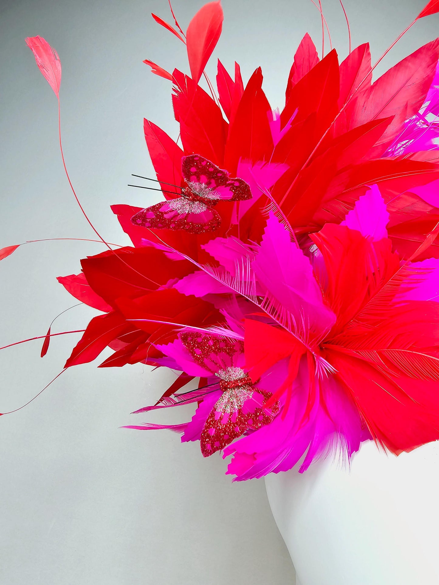 kentucky derby hat fascinator pink sinamay with scarlet red and fuchsia pink zigzag feather flower red pink feathers red pink butterflies