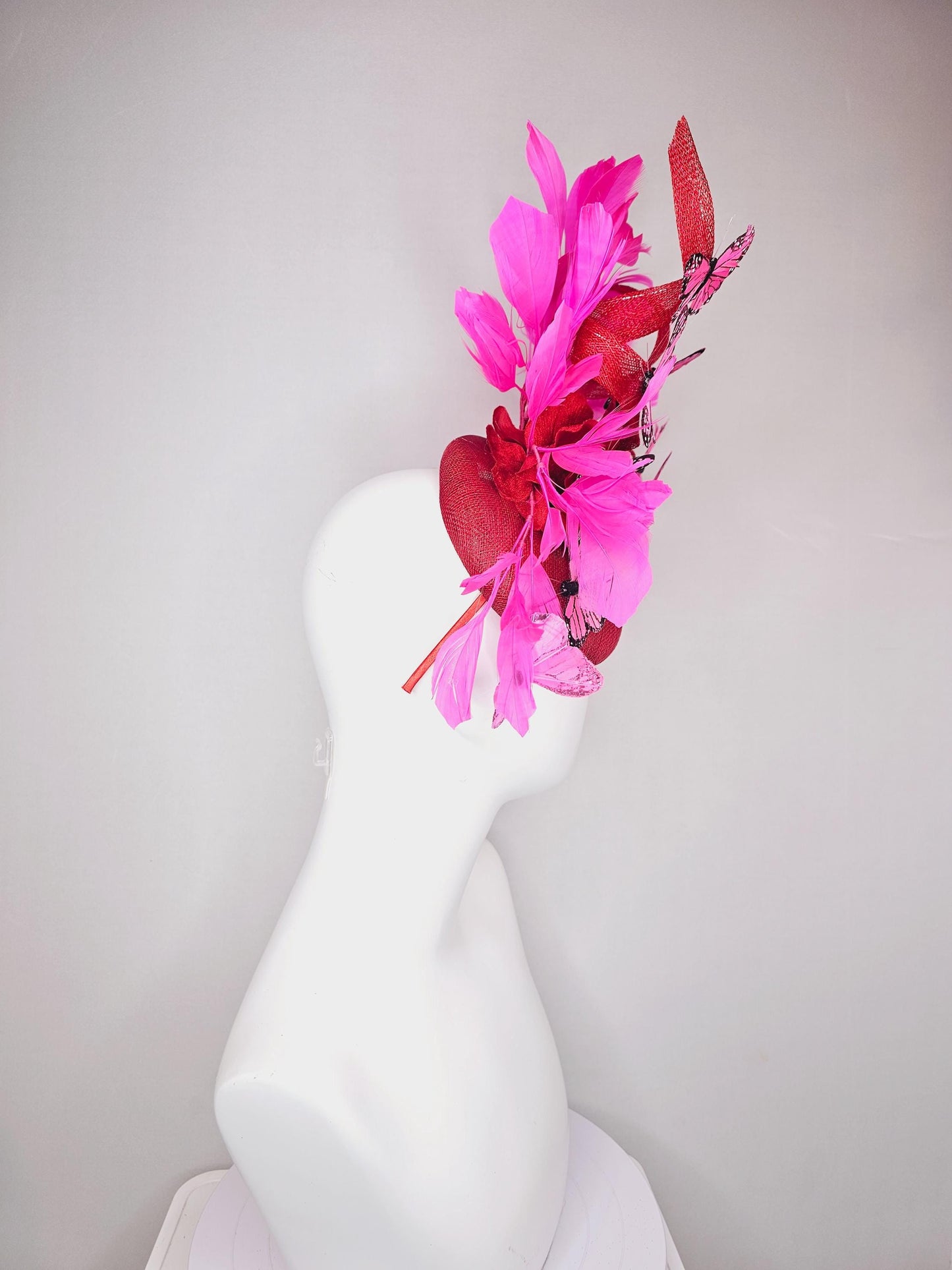 kentucky derby hat fascinator cherry red sinamay with curls hot pink fuchsia branching feathers and pink and black butterflies