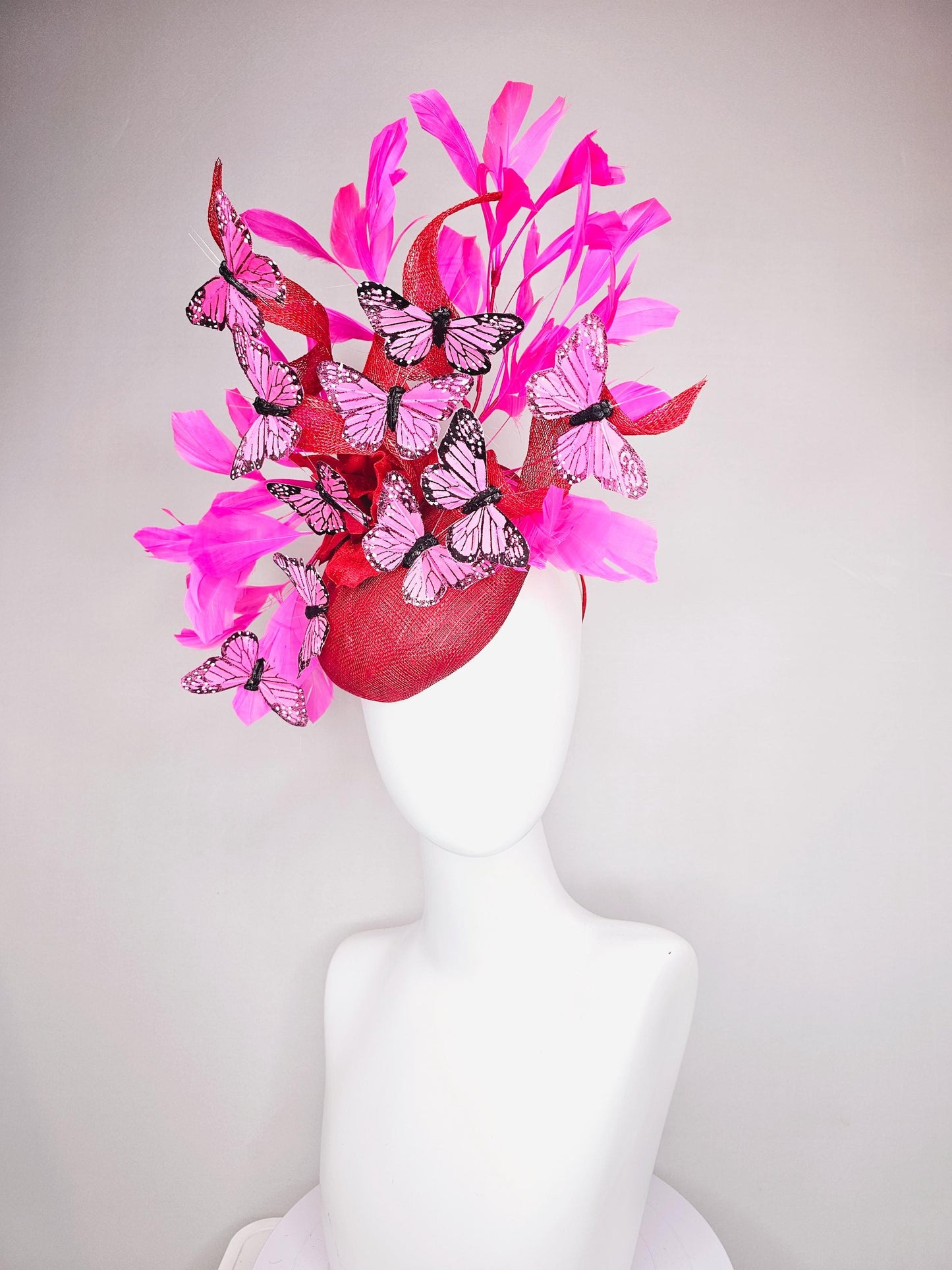 kentucky derby hat fascinator cherry red sinamay with curls hot pink fuchsia branching feathers and pink and black butterflies